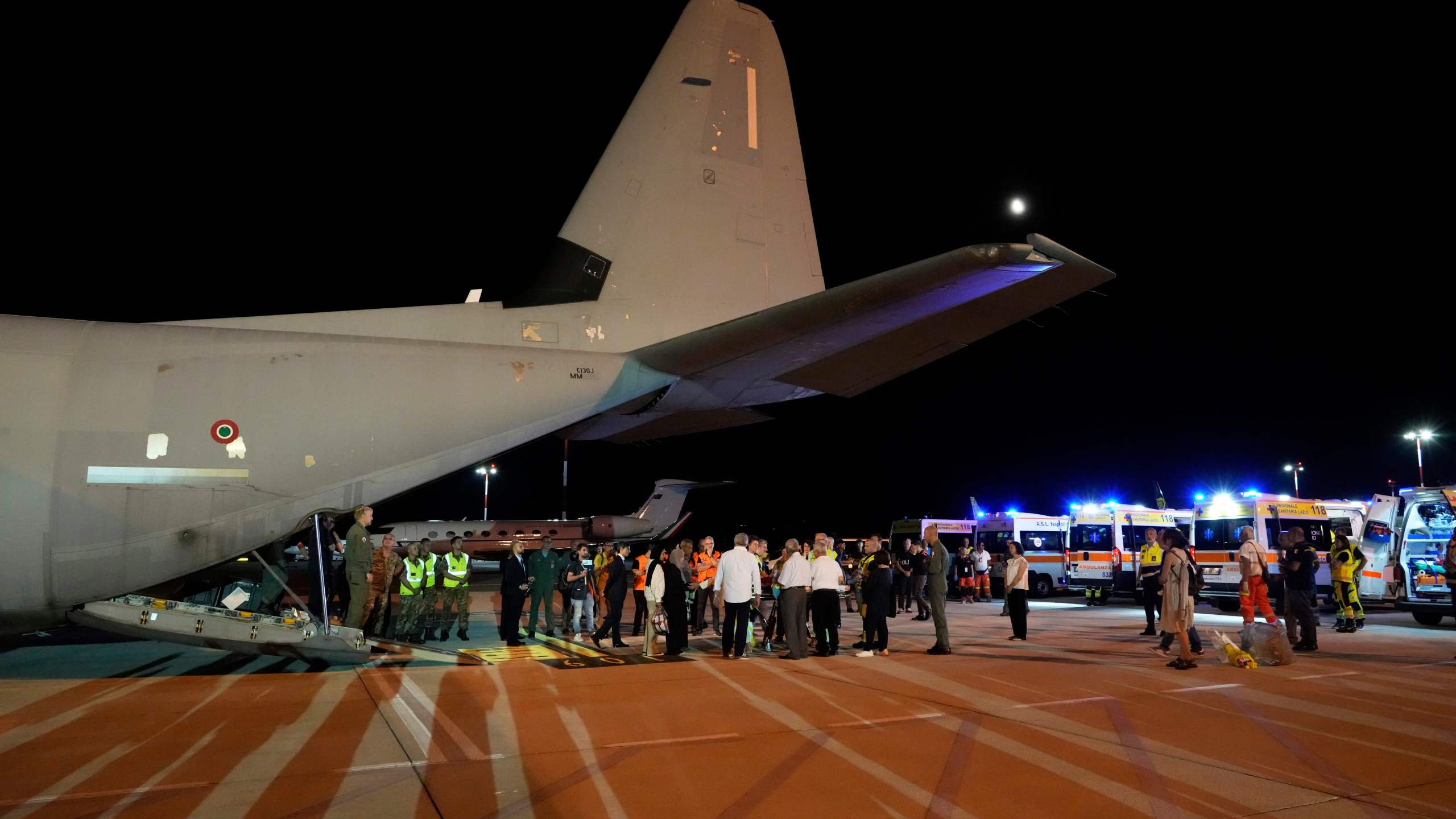 Palestinian children and their families evacuated from Gaza arrive at Rome's Ciampino military airport, Thursday, Aug. 14, 2025. (AP Photo/Gregorio Borgia)