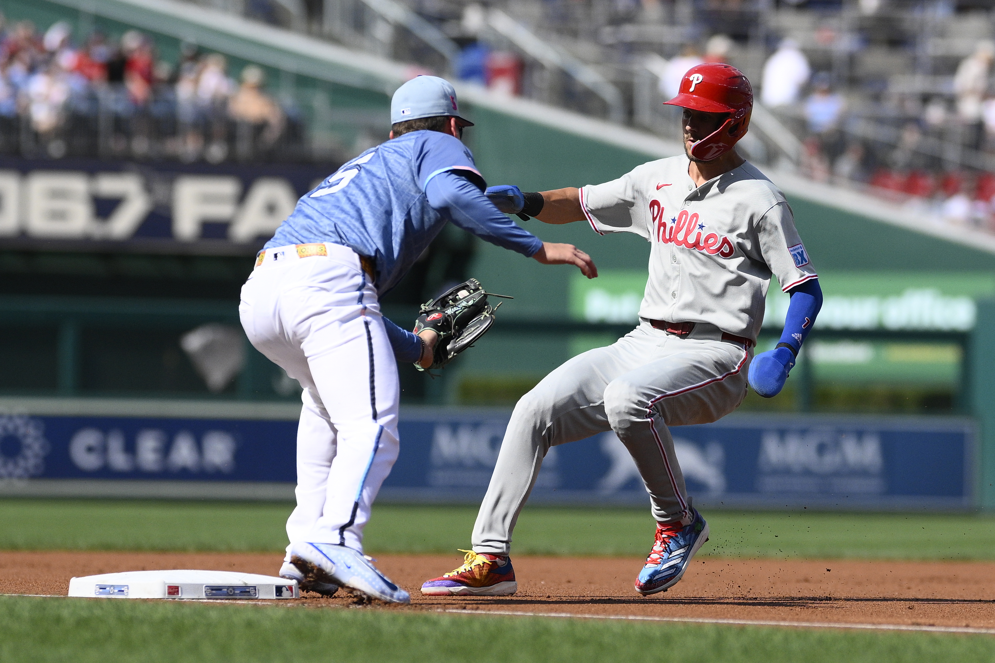 Philadelphia Phillies' Trea Turner, right, is caught attempting to steal third base by Washington Nationals third baseman Brady House, left, during the first inning of a baseball game, Saturday, Aug. 16, 2025, in Washington. (AP Photo/Nick Wass)