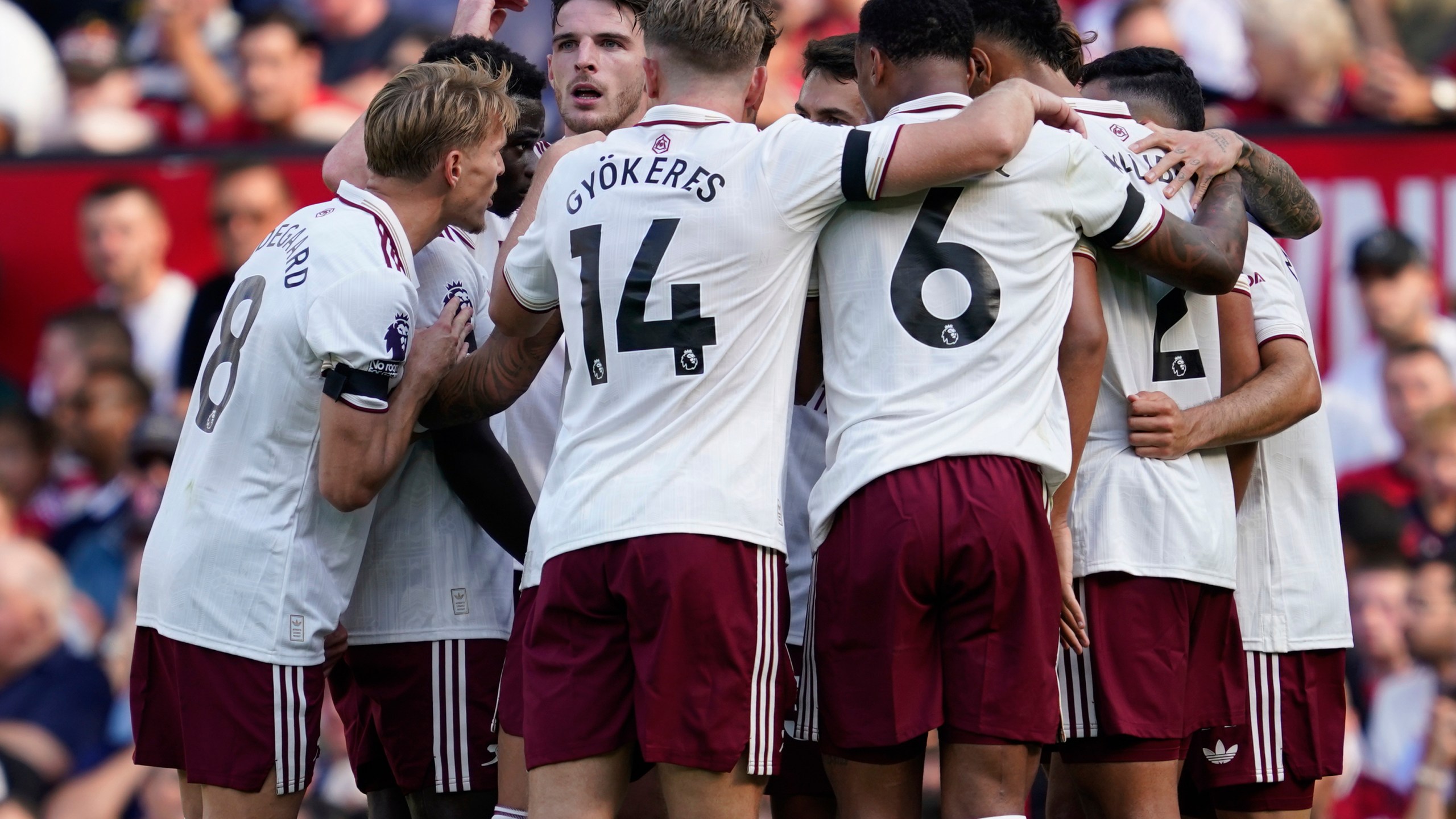 Arsenal's Riccardo Calafiori celebrates with teammates after scoring his sides first goal during the English Premier League soccer match between Manchester United and Arsenal at Old Trafford stadium in Manchester, England, Sunday, Aug. 17, 2025. (AP Photo/Dave Thompson)