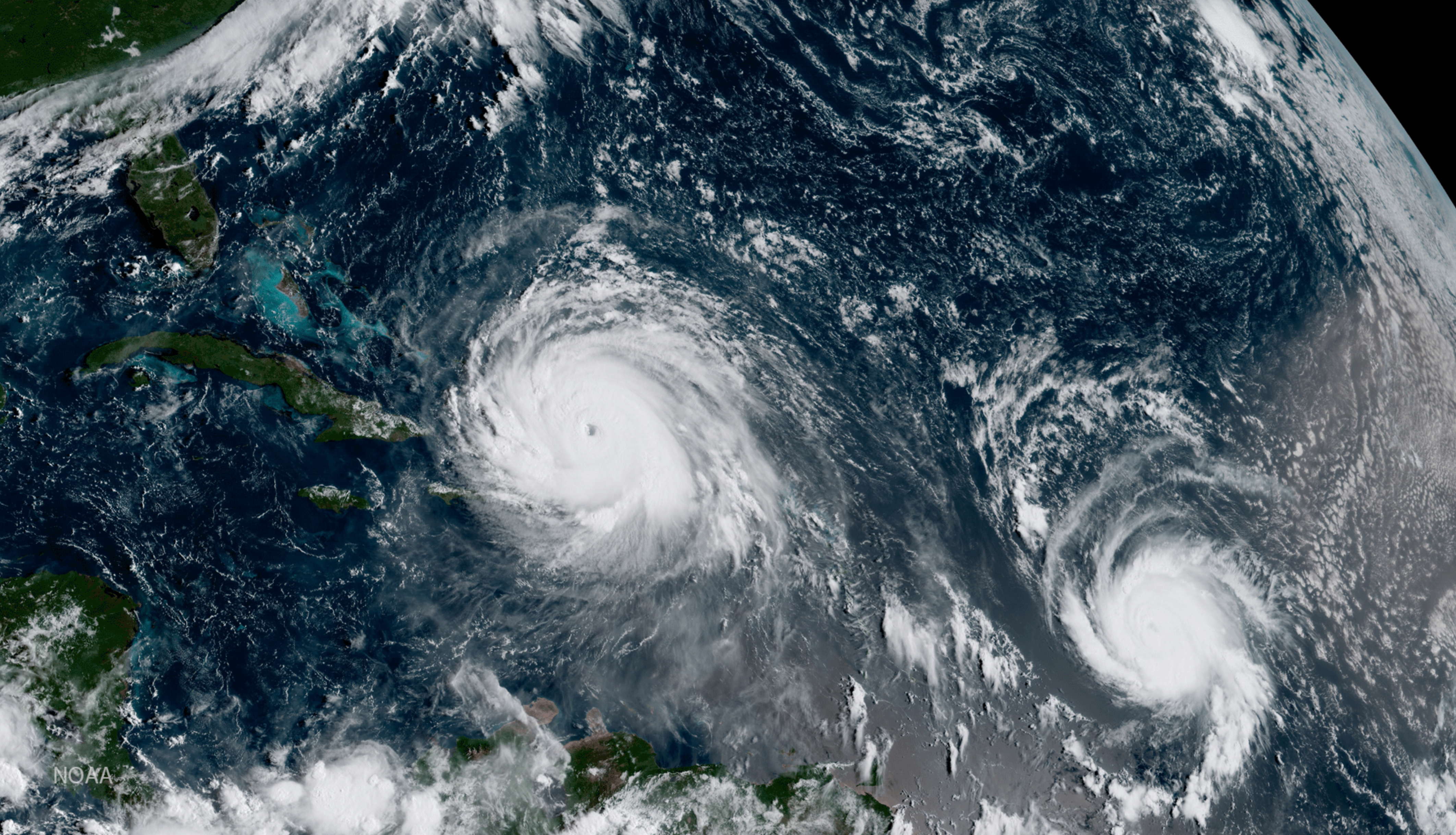 FILE - This Thursday, Sept. 7, 2017 satellite image made available by NOAA shows the eye of Hurricane Irma, left, just north of the island of Hispaniola, with Hurricane Jose, right, in the Atlantic Ocean. (NOAA via AP,File)