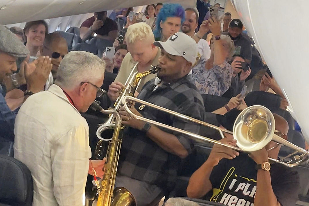 In this screenshot taken from video provided by Bridgeway Entertainment Inc, jazz musicians perform for their fellow passengers after their flight had suffered multiple delays on Monday, Aug. 11, 2025, in Boise, Idaho. (Bridgeway Entertainment Inc via AP)