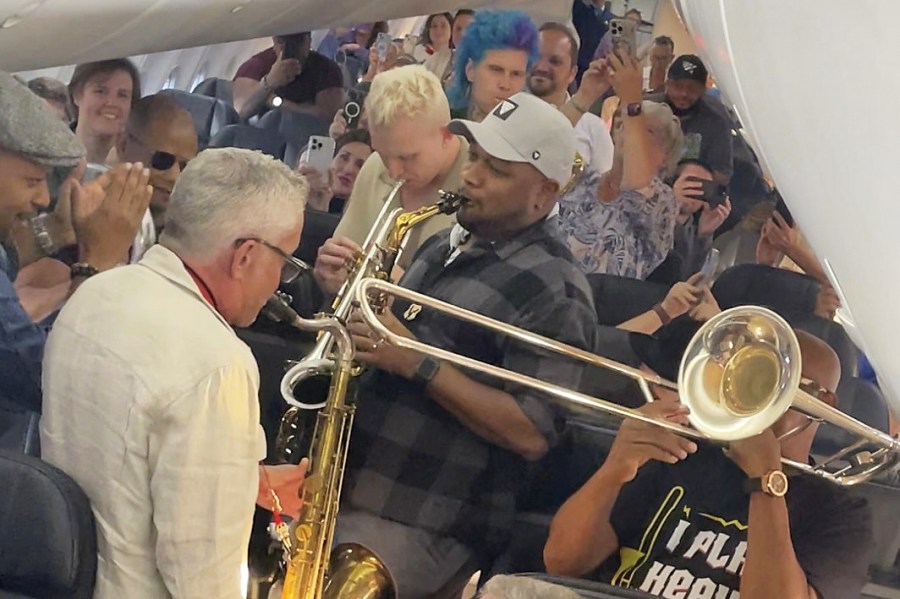 In this screenshot taken from video provided by Bridgeway Entertainment Inc, jazz musicians perform for their fellow passengers after their flight had suffered multiple delays on Monday, Aug. 11, 2025, in Boise, Idaho. (Bridgeway Entertainment Inc via AP)