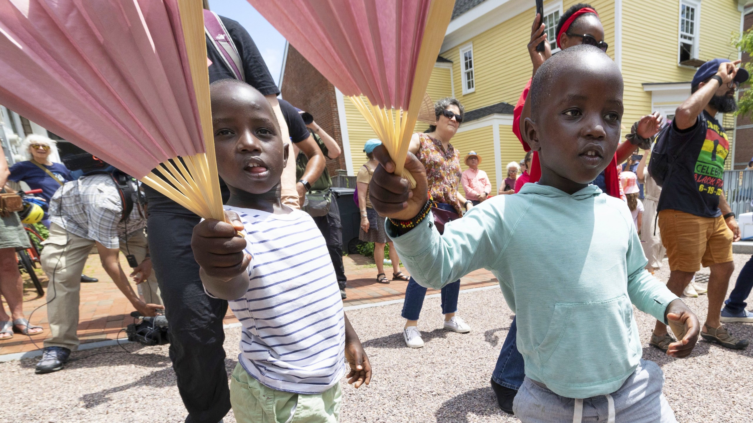 FILE - Levis Martin, left, and his brother Daniel dance with fans during a Juneteenth celebration in Portsmouth, N.H, on June 19, 2025. (AP Photo/Michael Dwyer, File)