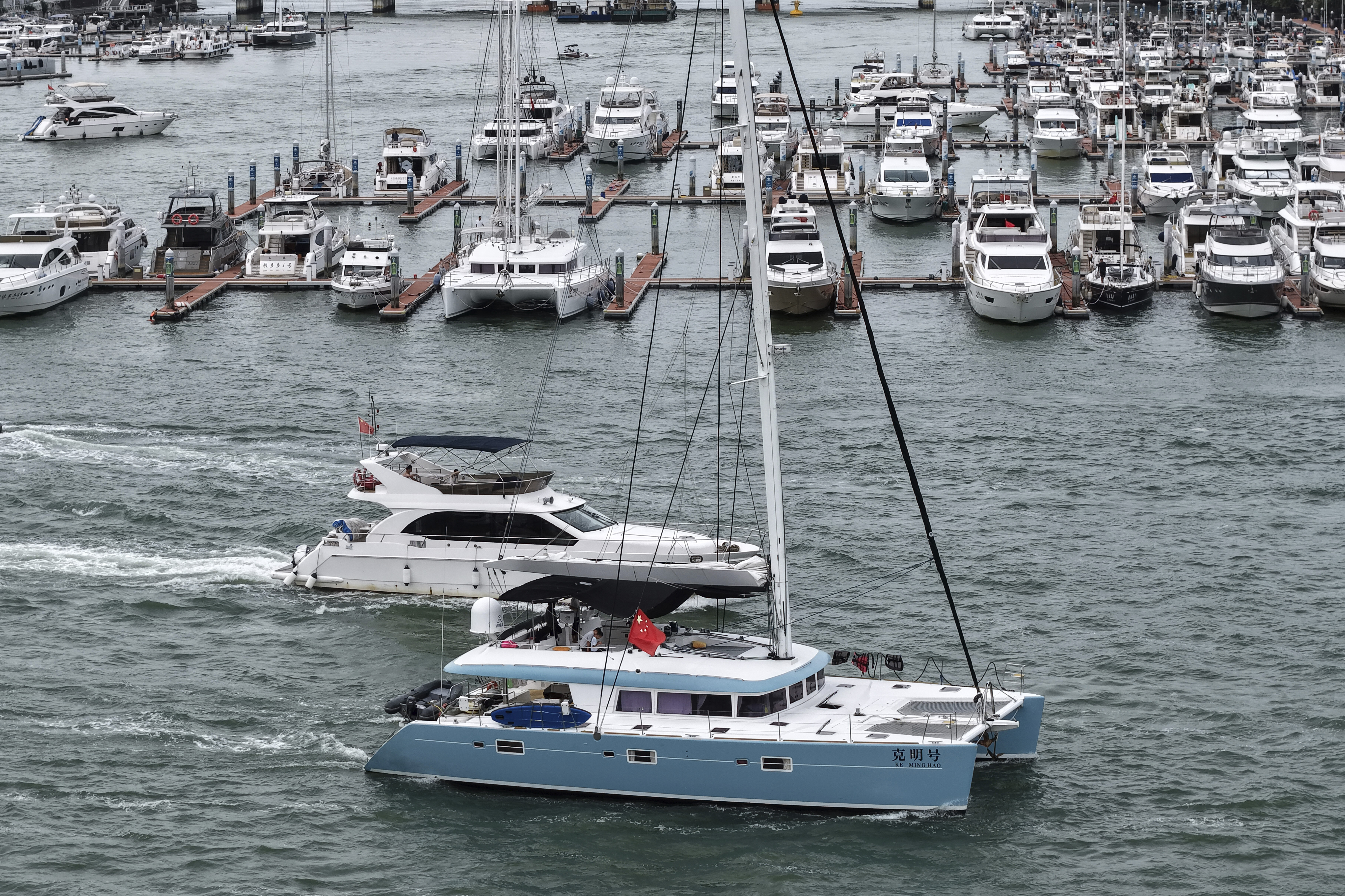 In this Aug. 23, 2025, aerial photo released by Xinhua News Agency, yachts return to dock ahead of Typhoon Kajiki in Sanya, southern China's Hainan Province. (Zhao Yingquan/Xinhua via AP)