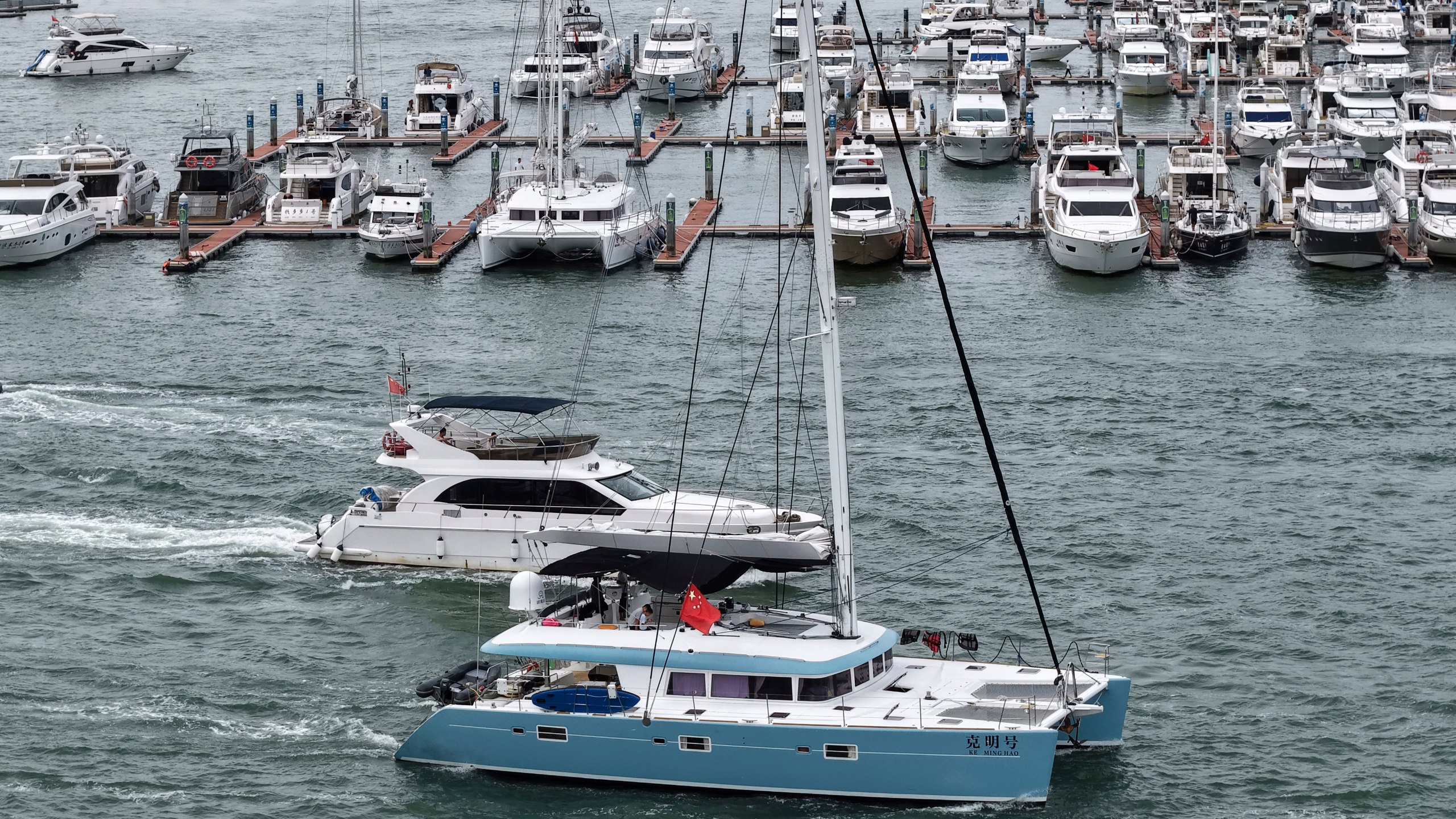 In this Aug. 23, 2025, aerial photo released by Xinhua News Agency, yachts return to dock ahead of Typhoon Kajiki in Sanya, southern China's Hainan Province. (Zhao Yingquan/Xinhua via AP)