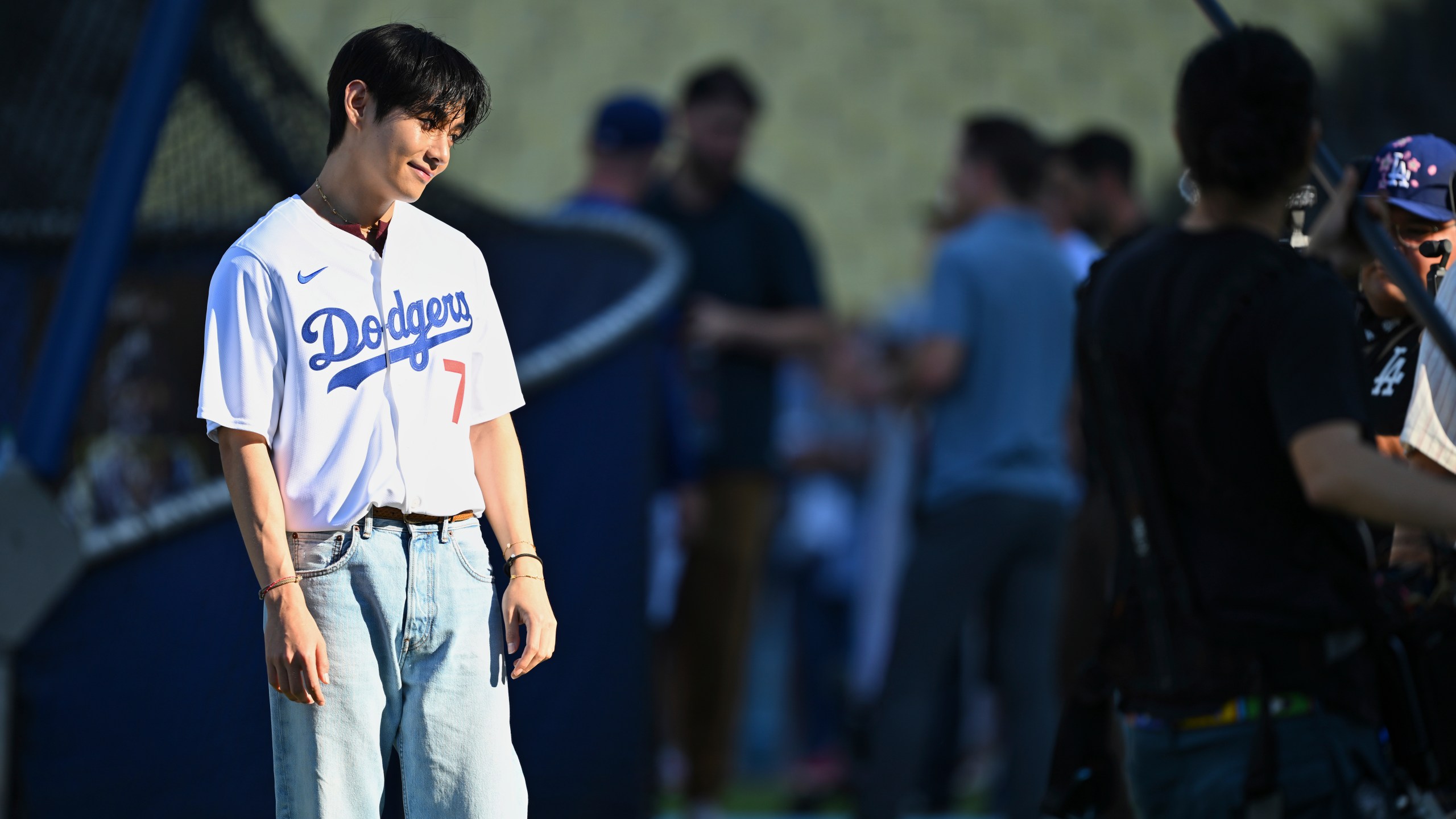 V, a member of the South Korean K-pop band BTS, looks on during batting practice before a baseball game between the Los Angeles Dodgers and the Cincinnati Reds Monday, Aug. 25, 2025, in Los Angeles. (AP Photo/Jayne Kamin-Oncea)