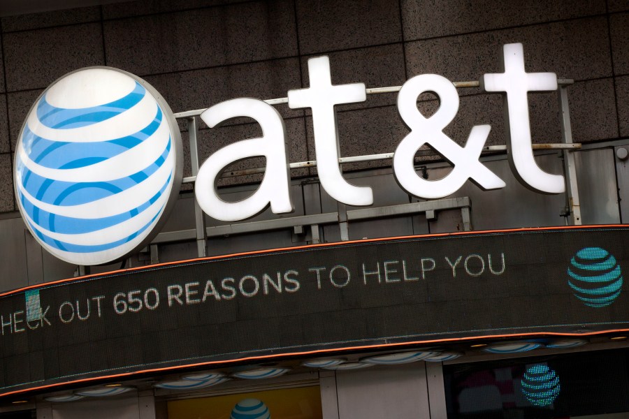 FILE - In this Oct. 24, 2016, file photo, the AT&T logo is positioned above one of its retail stores, in New York. (AP Photo/Mark Lennihan, File)