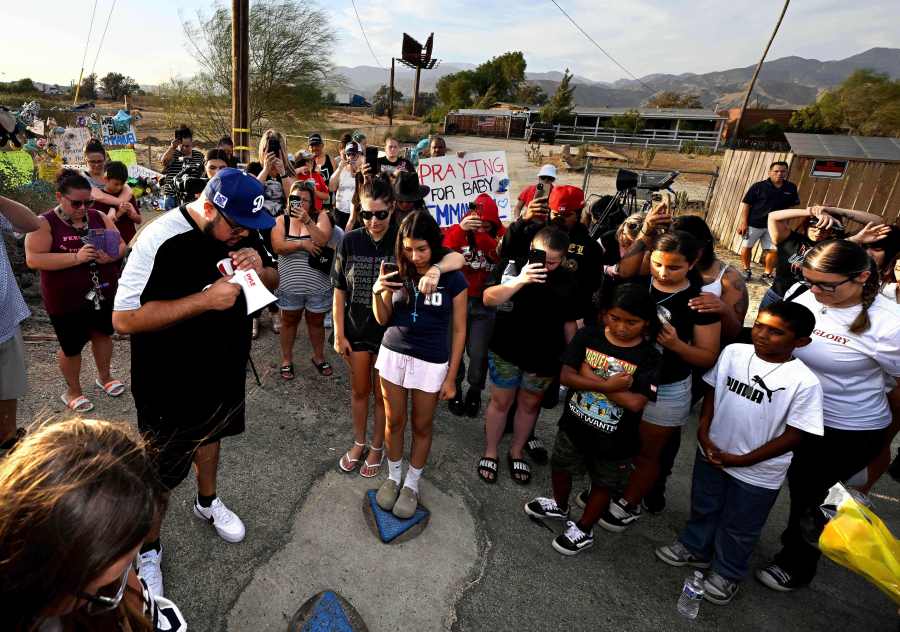 Local pastor David Hernandez, from Yucaipa, leads those gathered in prayer during a vigil for missing 7-month-old Emmanuel Haro outside the child's home in Cabazon, Calif. on Friday, Aug. 22, 2025. (Will Lester/The Orange County Register via AP)
