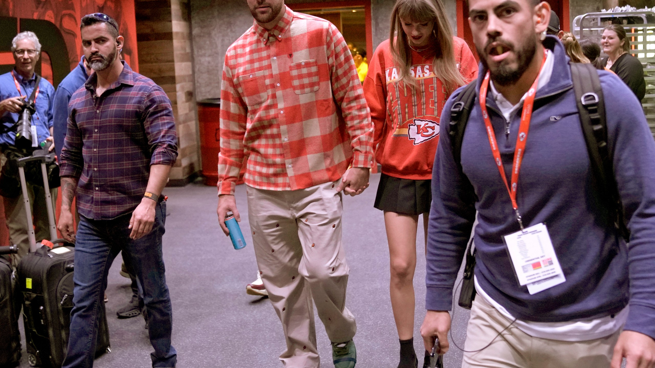 FILE - Kansas City Chiefs tight end Travis Kelce, center left, and singer Taylor Swift leave Arrowhead stadium after an NFL football game between the Chiefs and the Los Angeles Chargers in Kansas City, Mo., Oct. 22, 2023. (AP Photo/Charlie Riedel, File)
