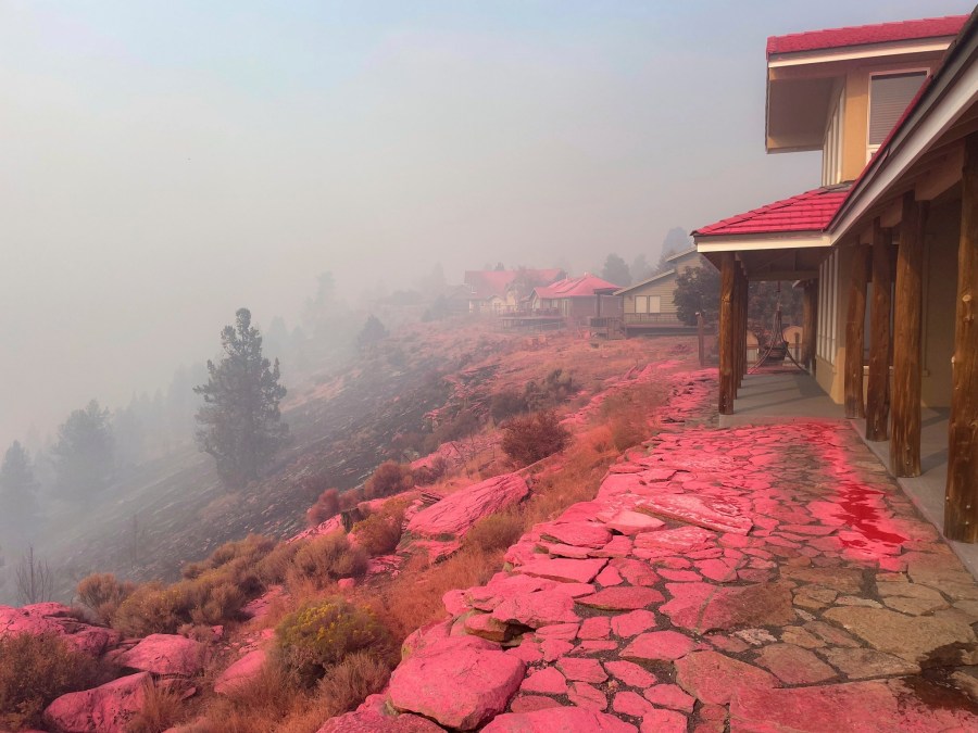 Deschutes County Sheriff's Office shows shows homes covered in fire retardant dropped from firefighting aircraft for battling the Flat Fire in central Oregon, Sunday, Aug. 24, 2025. (Deschutes County Sheriff's Office via AP)