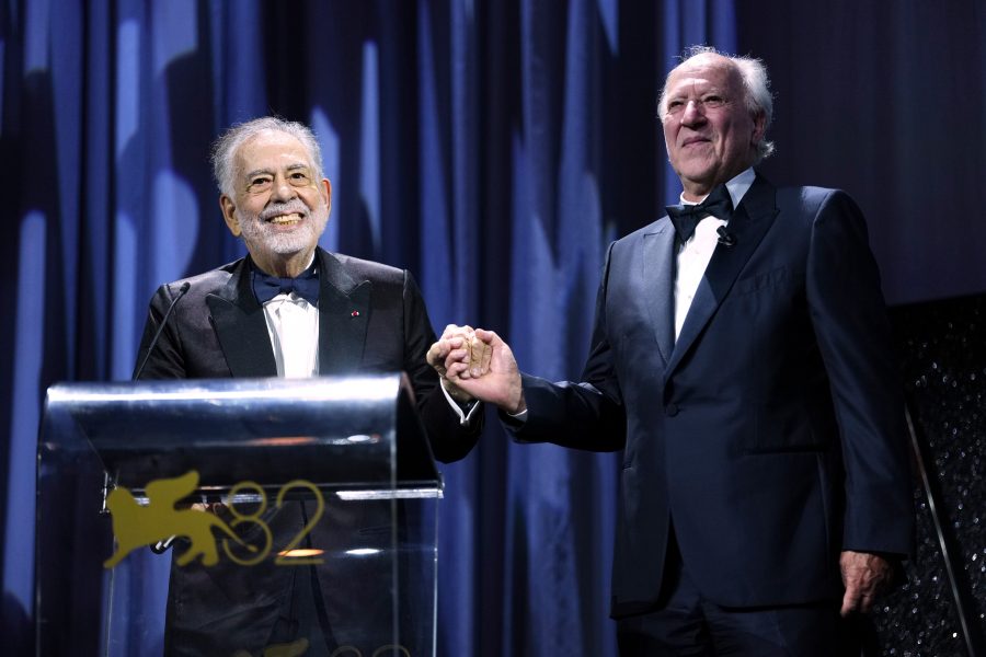 Francis Ford Coppola, left, presents the Golden Lion for lifetime achievement to Werner Herzog during the opening ceremony and the premiere of the film 'La Grazia' during the 82nd edition of the Venice Film Festival in Venice, Italy, on Wednesday, Aug. 27, 2025. (Photo by Scott A Garfitt/Invision/AP)