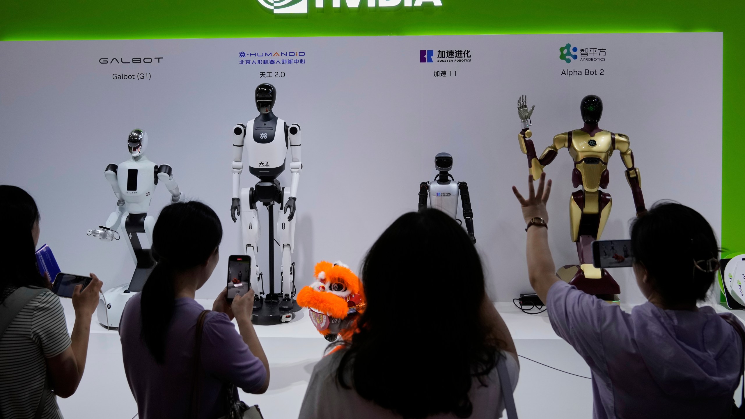 FILE - Visitors give commands to a robot at Nvidia's booth during the 3rd China International Supply Chain Expo at the China International Exhibition Center, in Beijing, July 18, 2025. (AP Photo/Mahesh Kumar A., File)