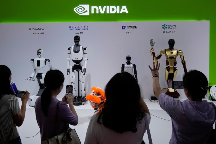 FILE - Visitors give commands to a robot at Nvidia's booth during the 3rd China International Supply Chain Expo at the China International Exhibition Center, in Beijing, July 18, 2025. (AP Photo/Mahesh Kumar A., File)