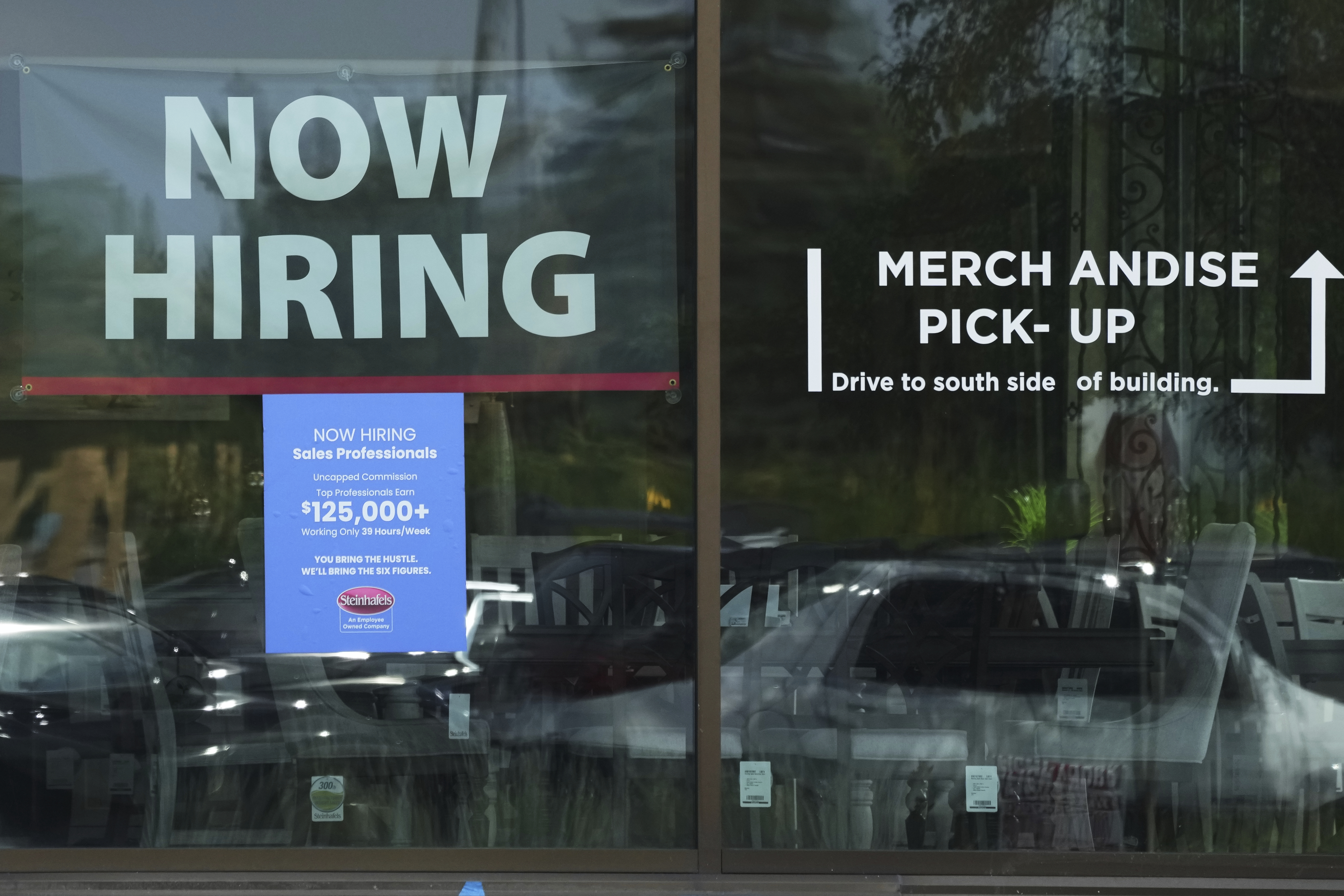 Now hiring sign is displayed at a retail store in Vernon Hills, Ill., Thursday, August. 7, 2025. (AP Photo/Nam Y. Huh)