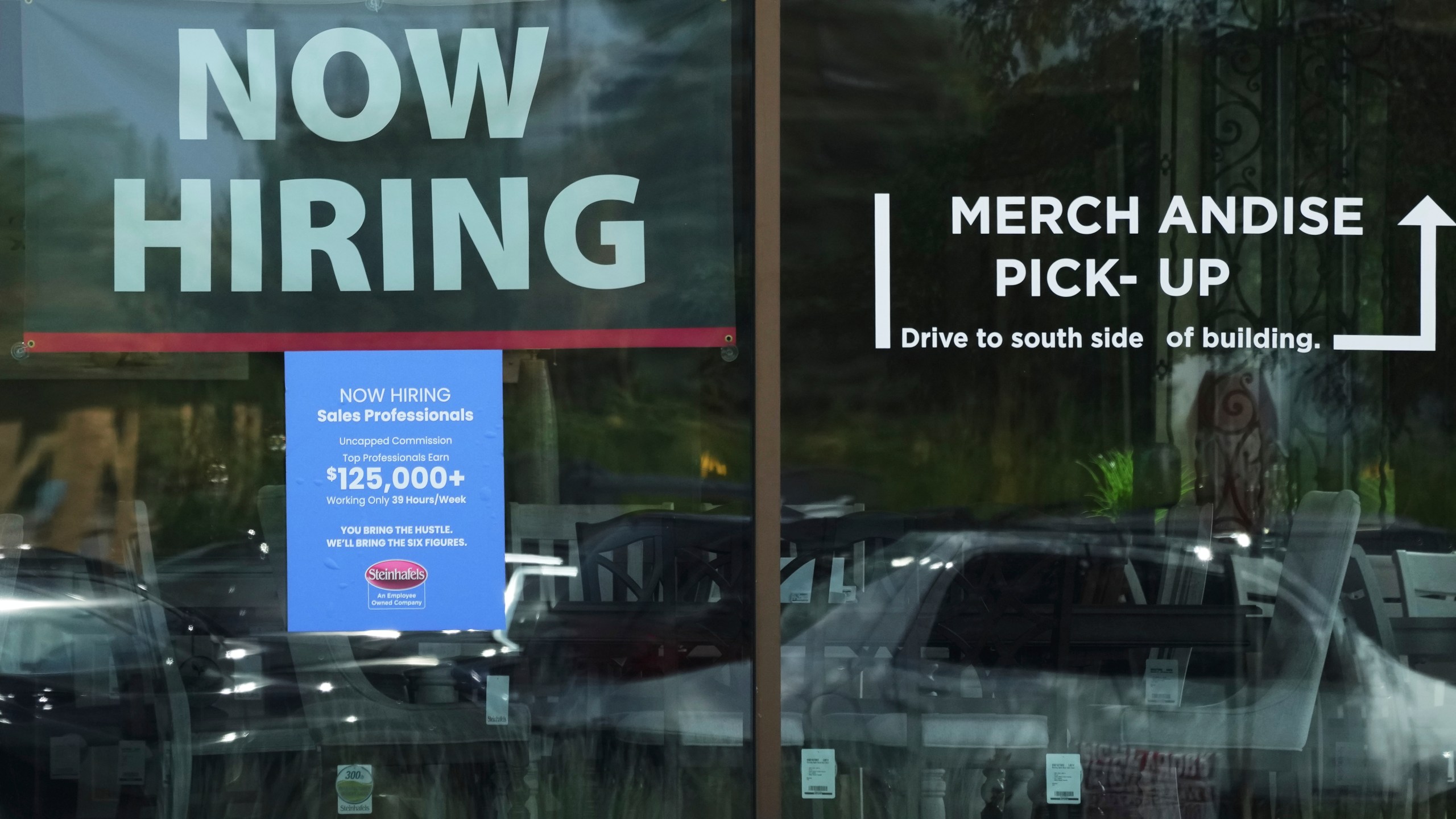 Now hiring sign is displayed at a retail store in Vernon Hills, Ill., Thursday, August. 7, 2025. (AP Photo/Nam Y. Huh)