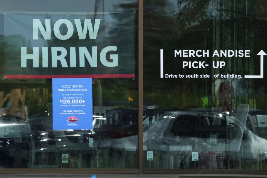 Now hiring sign is displayed at a retail store in Vernon Hills, Ill., Thursday, August. 7, 2025. (AP Photo/Nam Y. Huh)