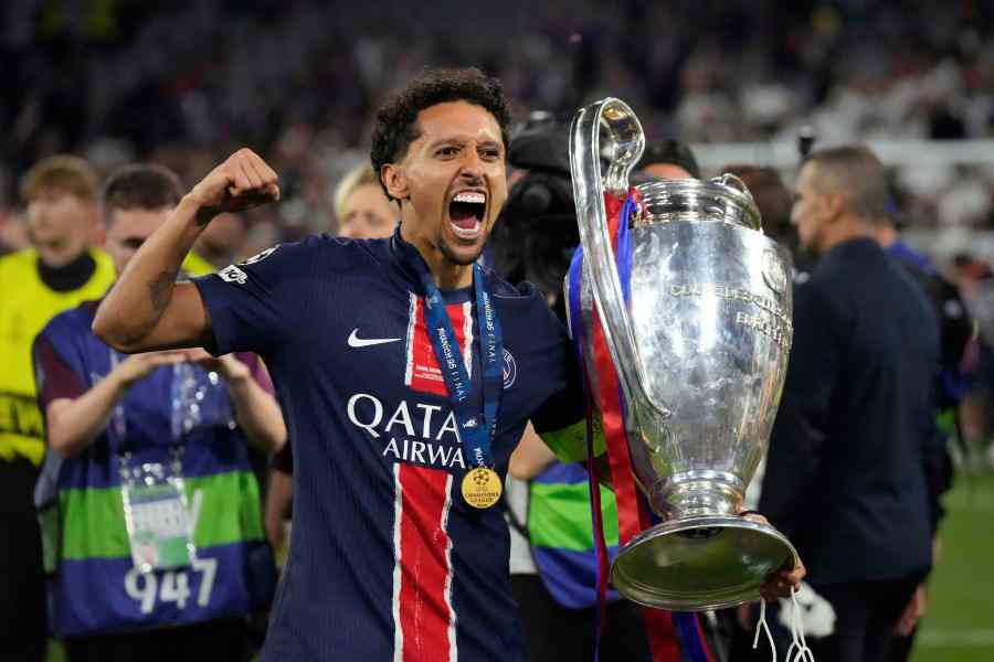 FILE - PSG's Marquinhos poses with the trophy after the Champions League final soccer match between Paris Saint-Germain and Inter Milan at the Allianz Arena in Munich, Germany, May 31, 2025. (AP Photo/Matthias Schrader, file)