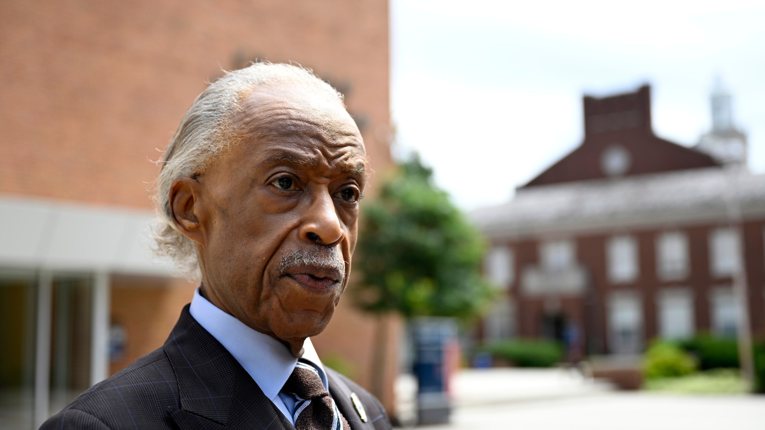 Rev. Al Sharpton speaks with reporters after delivering a sermon at Howard University's Cramton Auditorium, Sunday, Aug. 24, 2025, in Washington, to announce a national drive in support of District of Columbia Mayor Muriel Bowser, as President Donald Trump's administration continues it's use of federal law enforcement and National Guard troops in the city. (AP Photo/John McDonnell)
