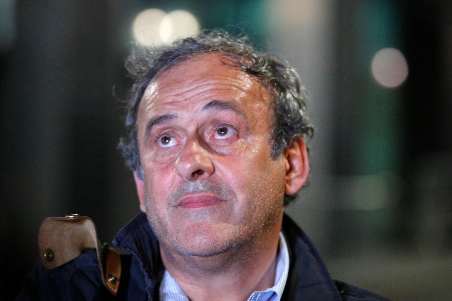 FILE - Michel Platini looks up after being freed, outside the French police anti-corruption and financial crimes office in Nanterre, outside Paris, June 19, 2019. (AP Photo/ Francois Mori, File)