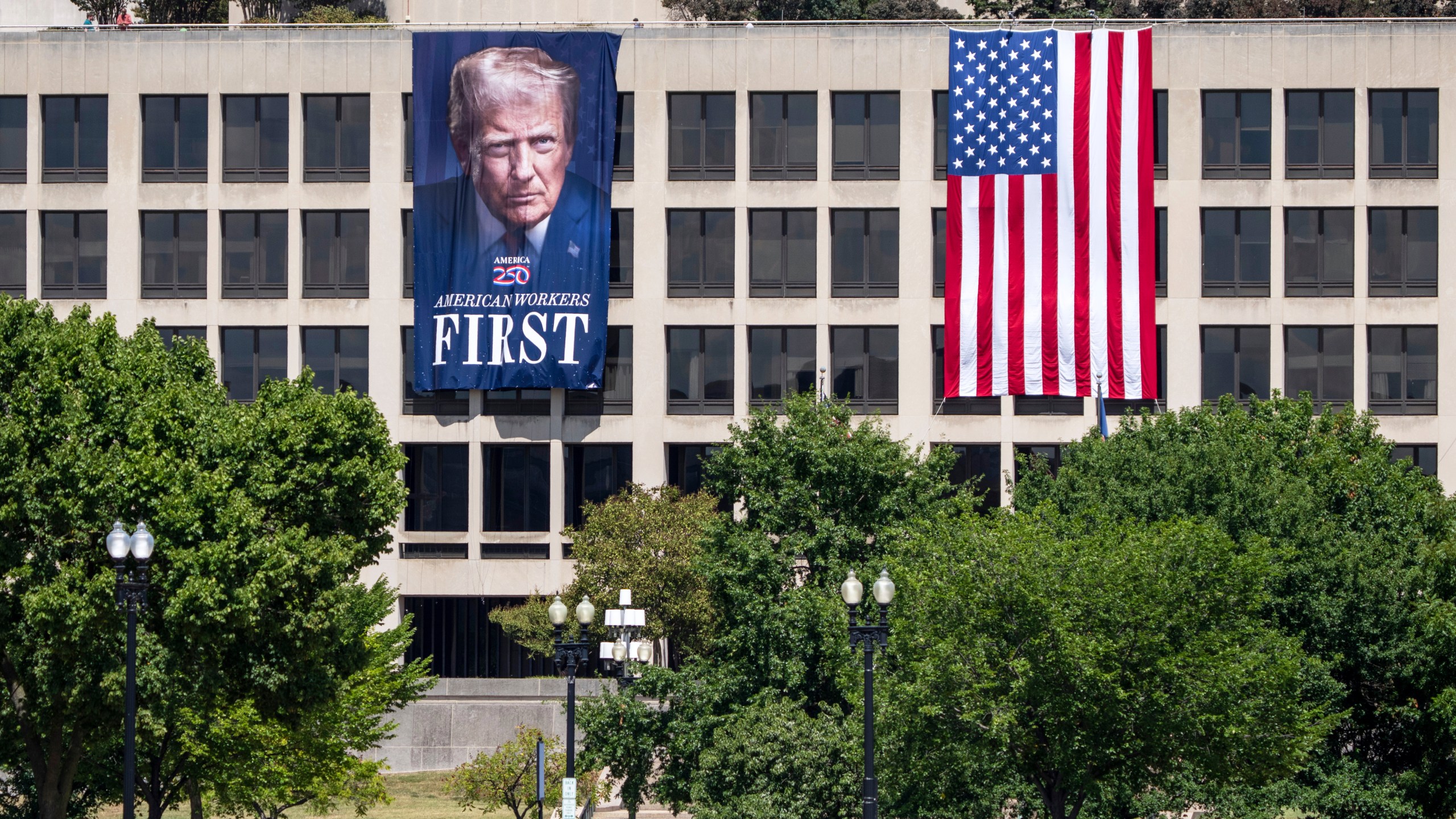 FILE - A portrait of President Donald Trump hangs on the Labor Department headquarters near the Capitol in Washington, Aug. 25, 2025. (AP Photo/J. Scott Applewhite, file)
