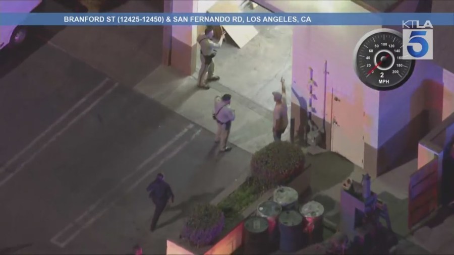 The male suspect ditched the stolen SUV in Pacoima and ran into a warehouse-type building where he barricaded himself on Aug. 12, 2025. (KTLA)