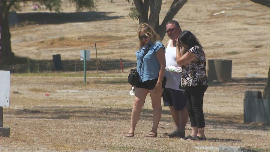 Locals said they're visiting Woodlawn Cemetery more often to ensure their loved ones' gravesites are intact. (KTLA)