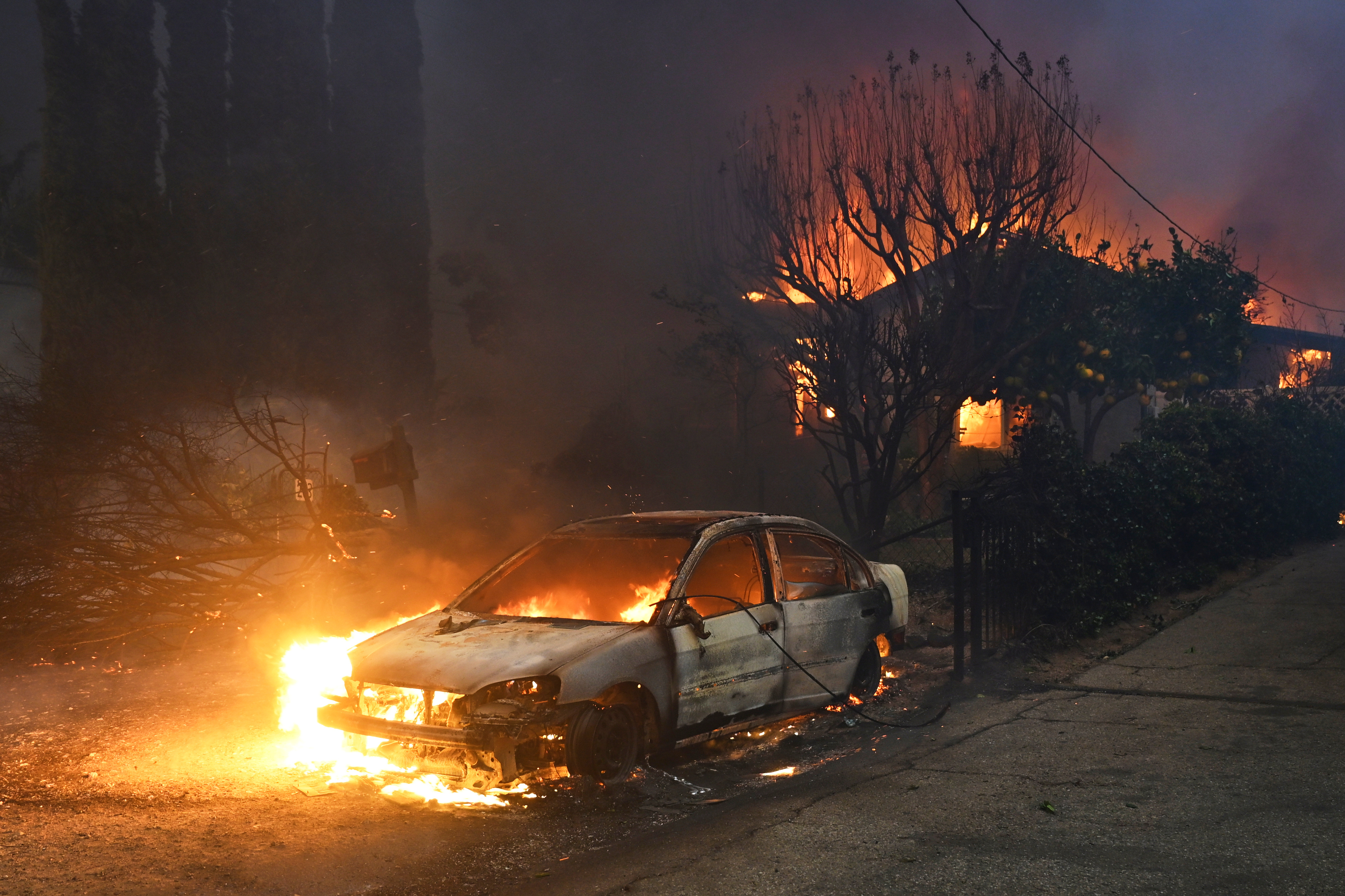 FILE - The Eaton Fire burns vehicles and structures Wednesday, Jan. 8, 2025 in Altadena, Calif. (AP Photo/Nic Coury, File)