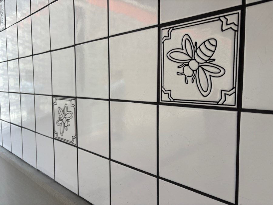 Bumble bee tiles are seen at the new Glendora Station along the Metro A Line on Sept. 19, 2025. (Travis Schlepp/KTLA)
