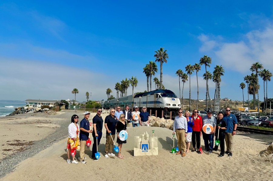 OCTA Board Members and executives gather with federal, state and local elected leaders on Sept. 5, 2025, to mark the beginning of sand nourishment in San Clemente to help protect the coastal rail line. (Orange County Transportation Authority)