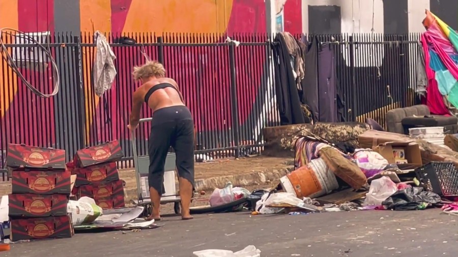 During the daytime, some people are seen picking through the rotten produce for anything edible. (KTLA)