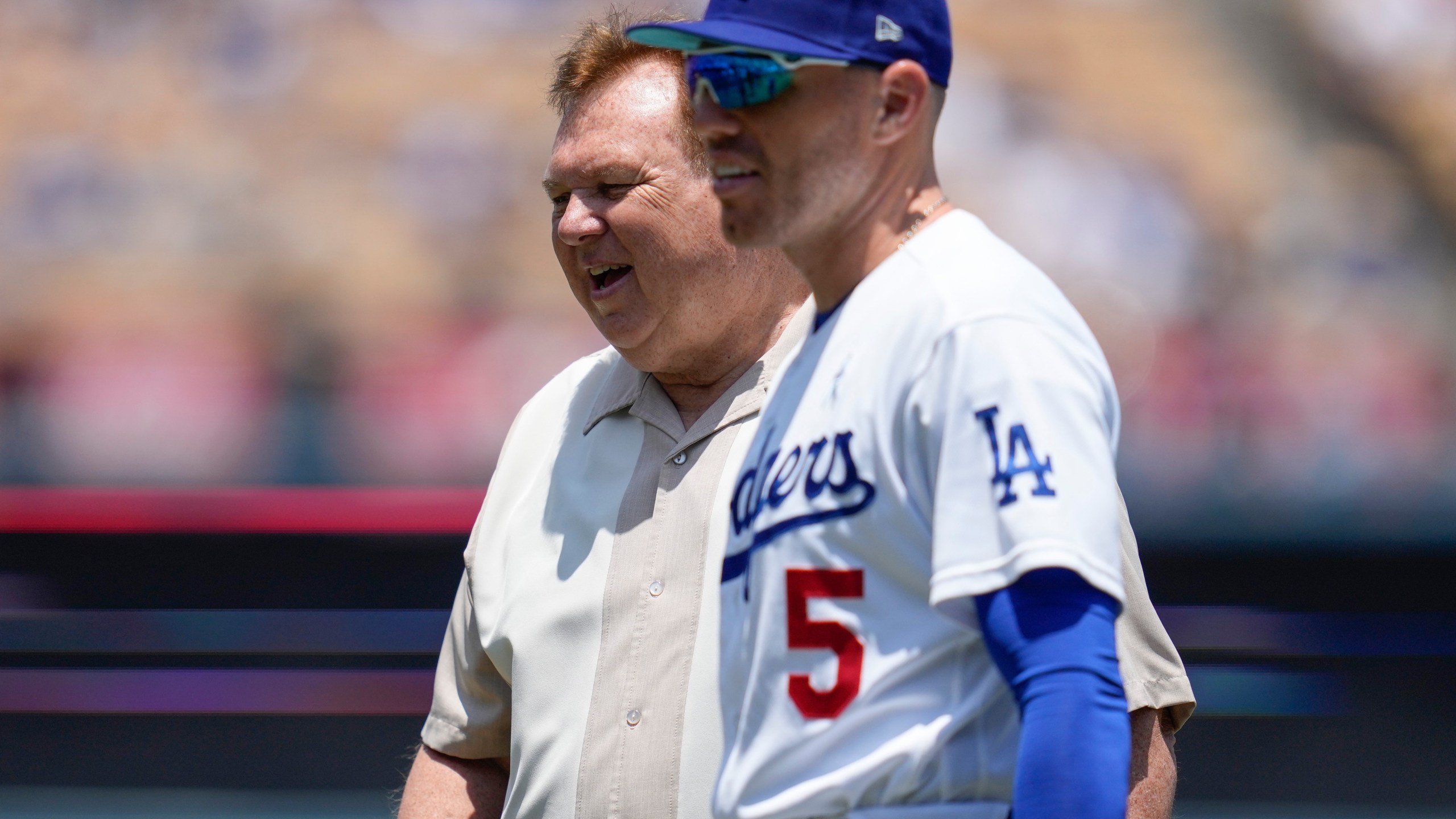 FILE - Los Angeles Dodgers first baseman Freddie Freeman (5) on the field walks with his father, Fred Freeman, before a baseball game against the San Francisco Giants in Los Angeles, Sunday, June 18, 2023. (AP Photo/Ashley Landis, File)