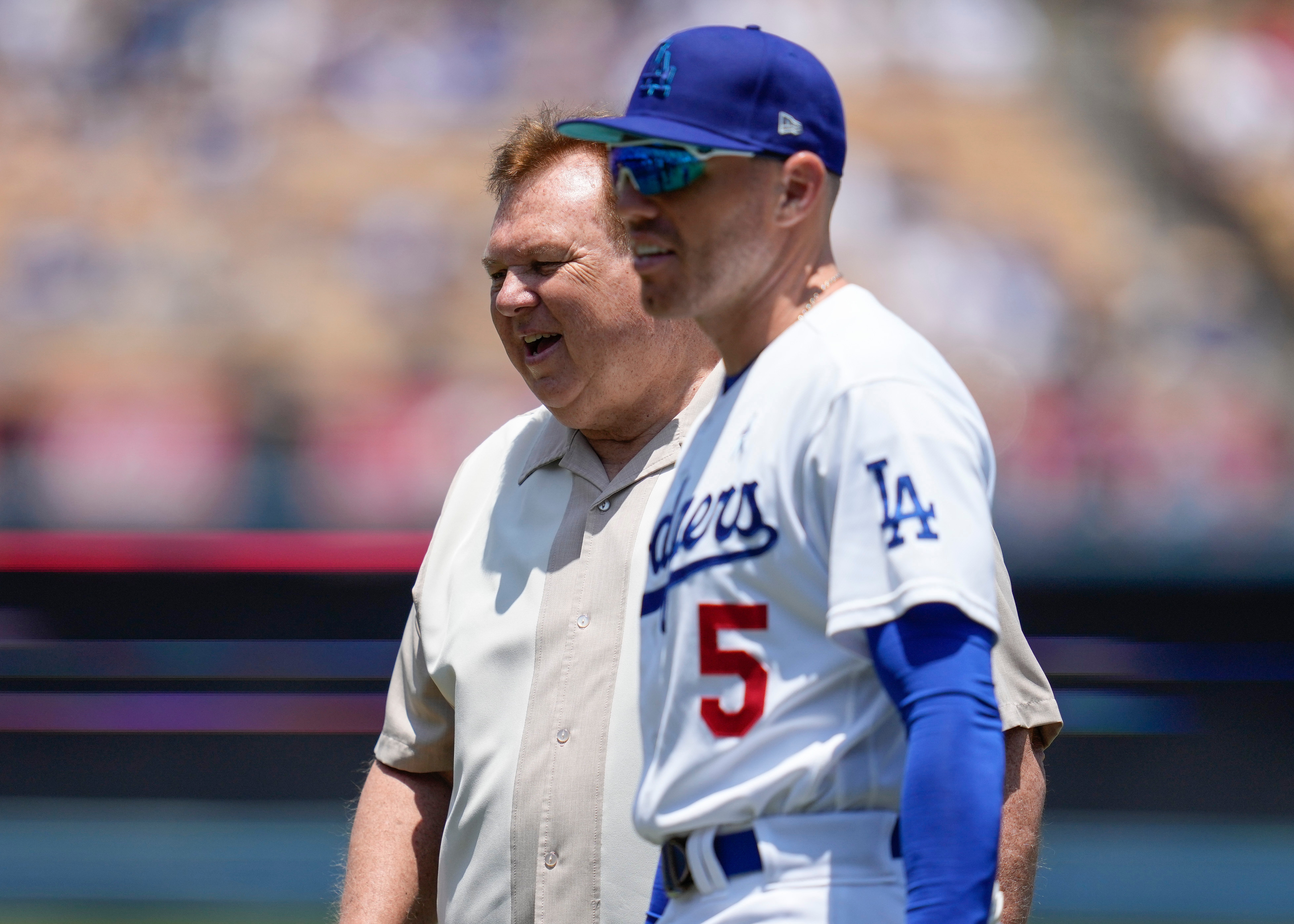 FILE - Los Angeles Dodgers first baseman Freddie Freeman (5) on the field walks with his father, Fred Freeman, before a baseball game against the San Francisco Giants in Los Angeles, Sunday, June 18, 2023. (AP Photo/Ashley Landis, File)
