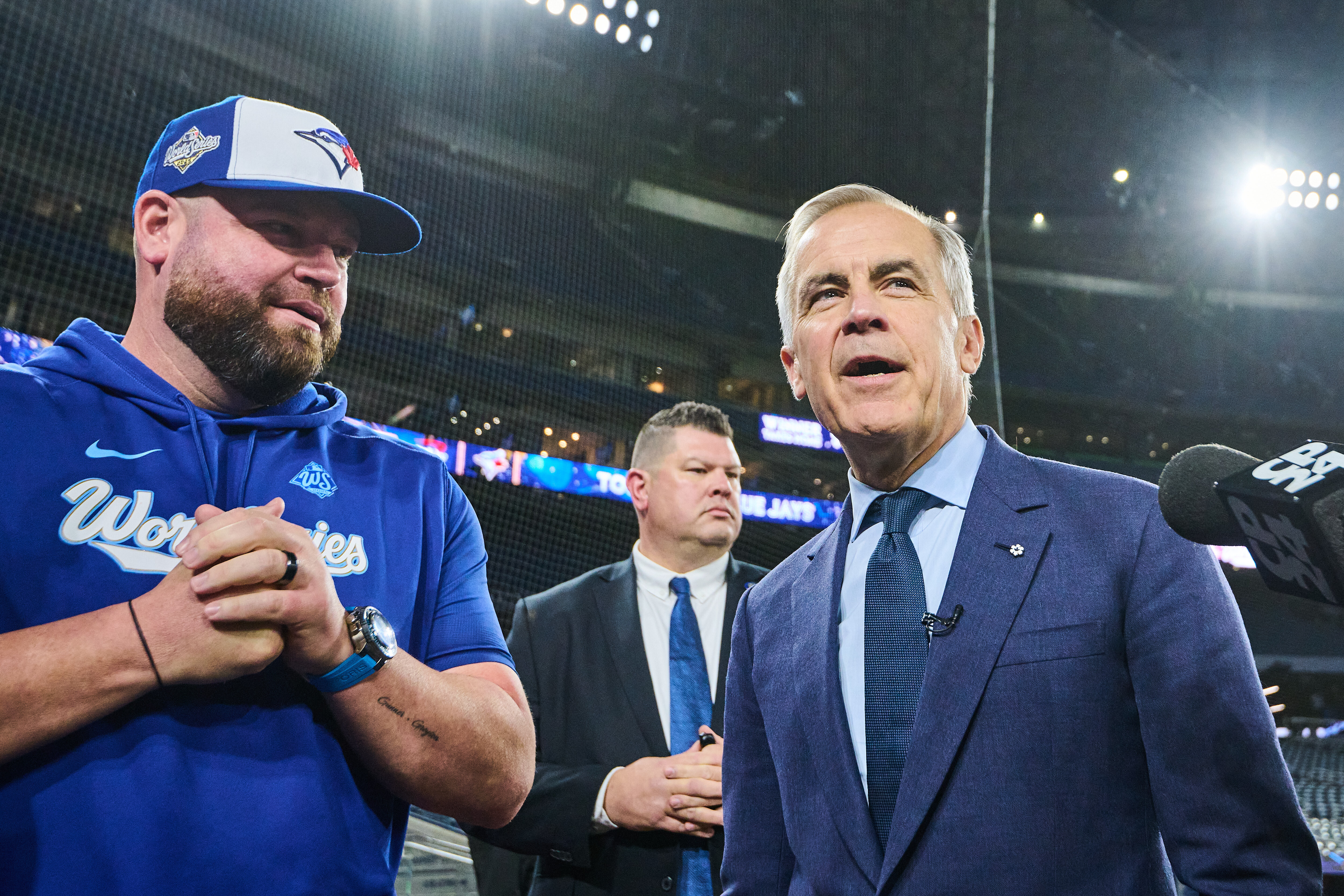 Canada's Prime Minister Mark Carney speaks to Toronto Blue Jays manager John Schneider as he visits the Blue Jays during baseball's World Series media day, Thursday, Oct. 23, 2025, in Toronto,. (Sammy Kogan/The Canadian Press via AP)