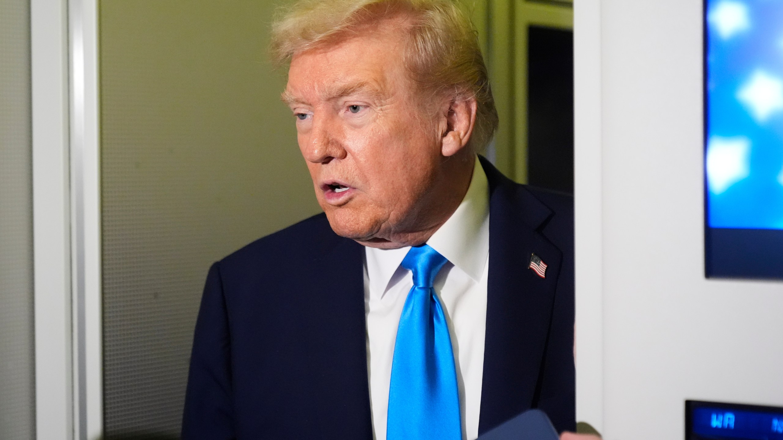 President Donald Trump speaks with reporters aboard Air Force One at Al Udeid Air Base in Doha, Qatar, Saturday, Oct. 25, 2025. (AP Photo/Mark Schiefelbein)