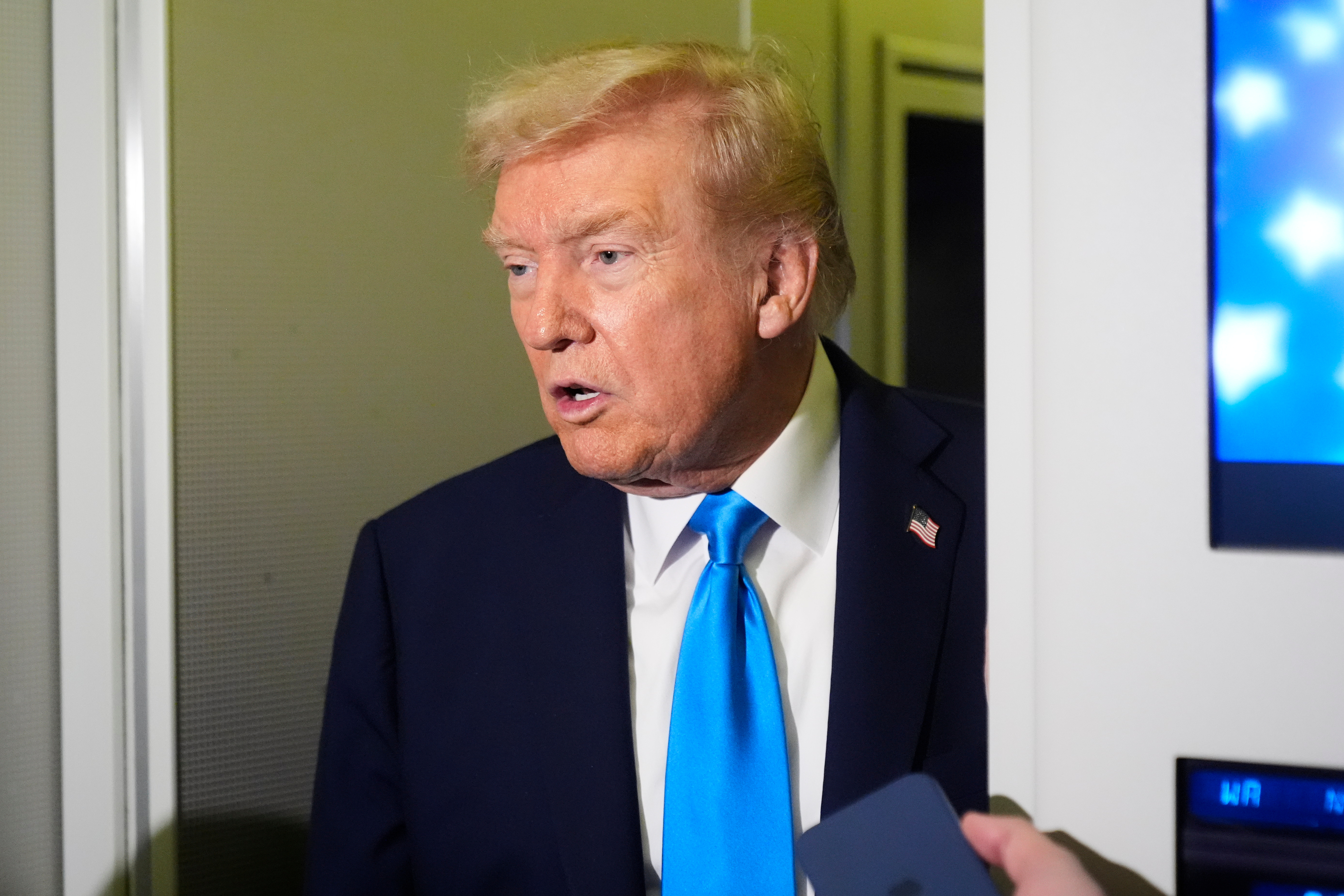 President Donald Trump speaks with reporters aboard Air Force One at Al Udeid Air Base in Doha, Qatar, Saturday, Oct. 25, 2025. (AP Photo/Mark Schiefelbein)