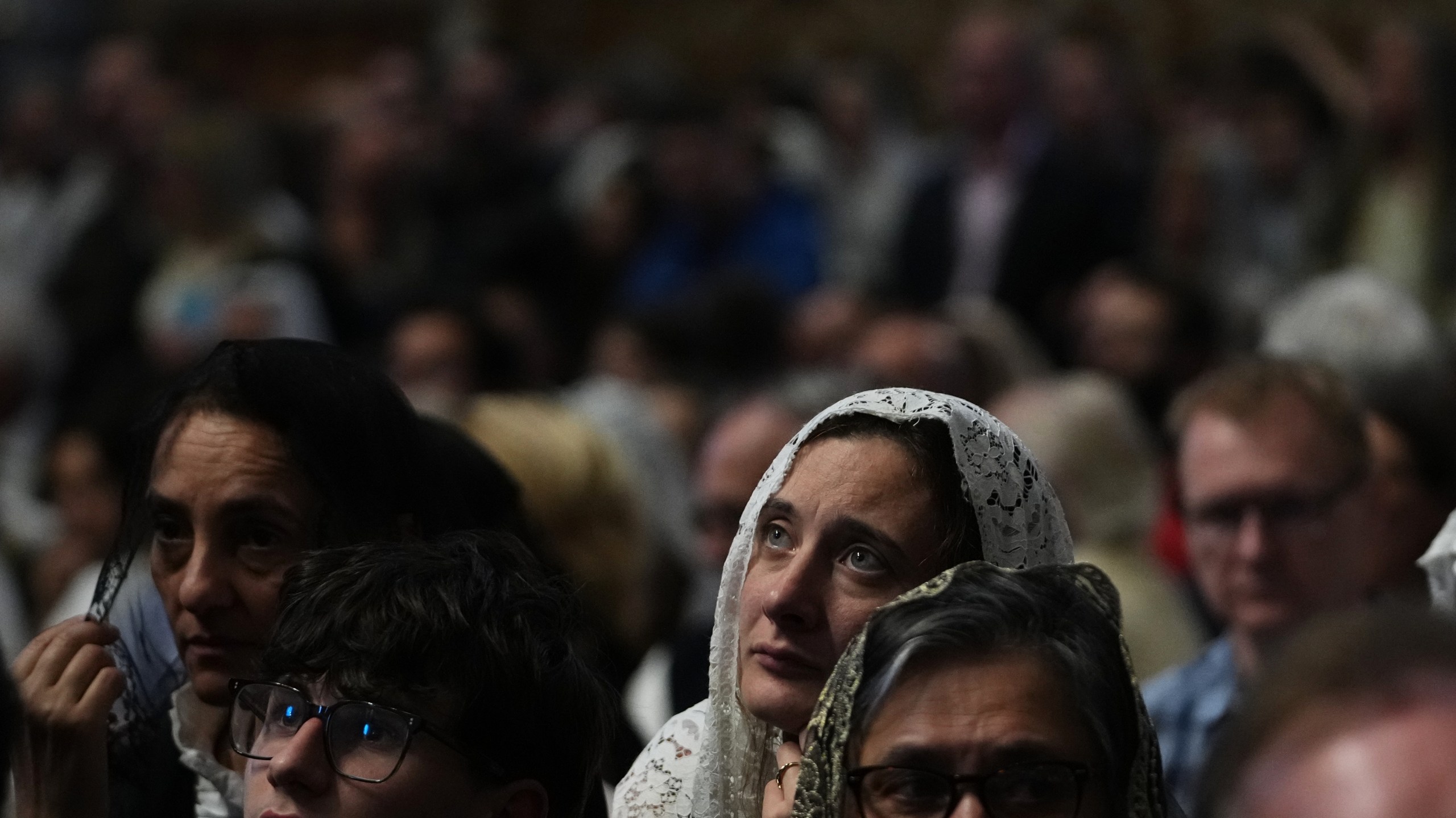 A woman attends a mass celebrated by Cardinal Raymond Leo Burke in St. Peter's Basilica, at the Vatican, Saturday, Oct. 25, 2025. (AP Photo/Alessandra Tarantino)