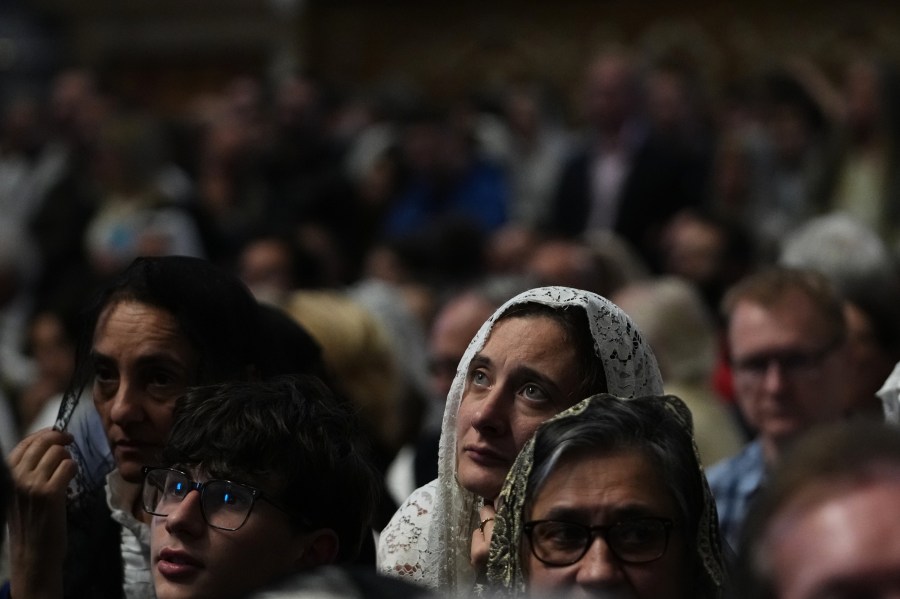 A woman attends a mass celebrated by Cardinal Raymond Leo Burke in St. Peter's Basilica, at the Vatican, Saturday, Oct. 25, 2025. (AP Photo/Alessandra Tarantino)