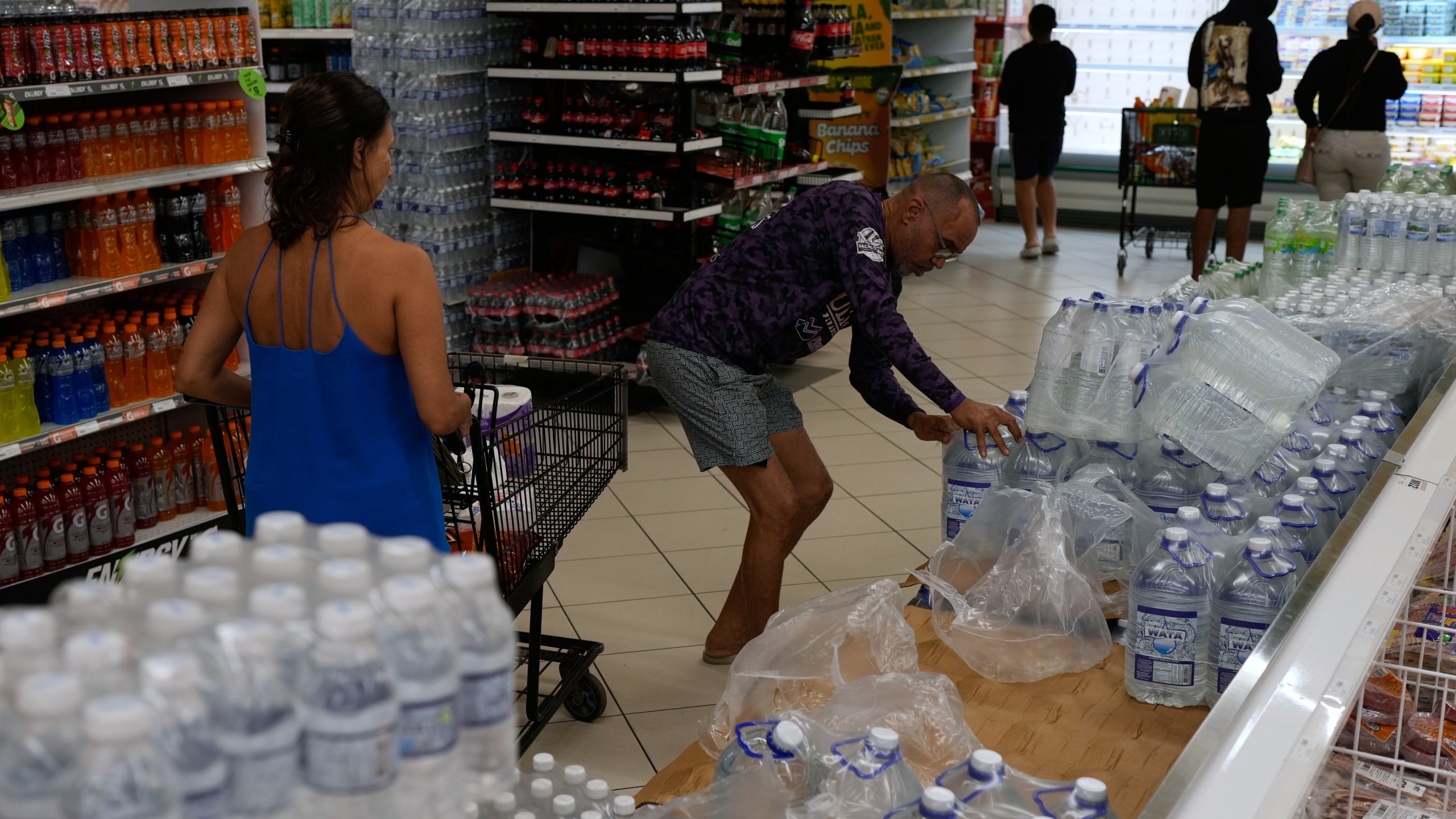 People buy groceries ahead of the forecast arrival of Hurricane Melissa in Kingston, Jamaica, Sunday, Oct. 26, 2025. (AP Photo/Matias Delacroix)