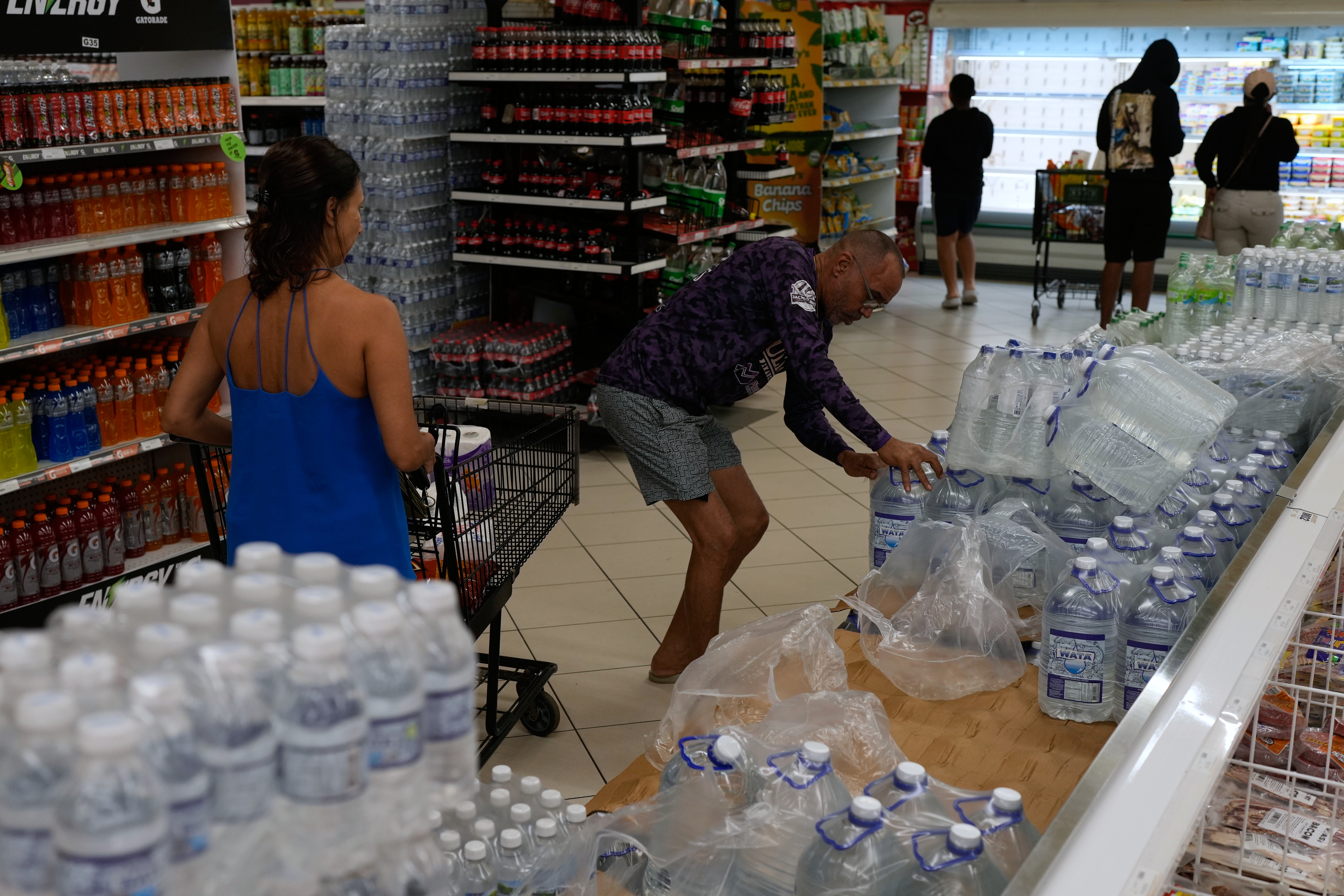 People buy groceries ahead of the forecast arrival of Hurricane Melissa in Kingston, Jamaica, Sunday, Oct. 26, 2025. (AP Photo/Matias Delacroix)