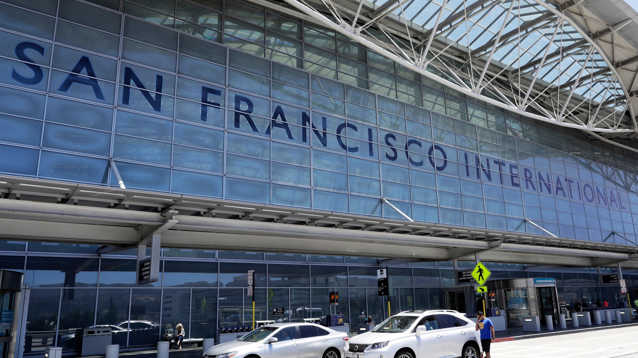 FILE - Vehicles wait outside the international terminal at San Francisco International Airport in San Francisco, July 11, 2017. (AP Photo/Marcio Jose Sanchez, File)