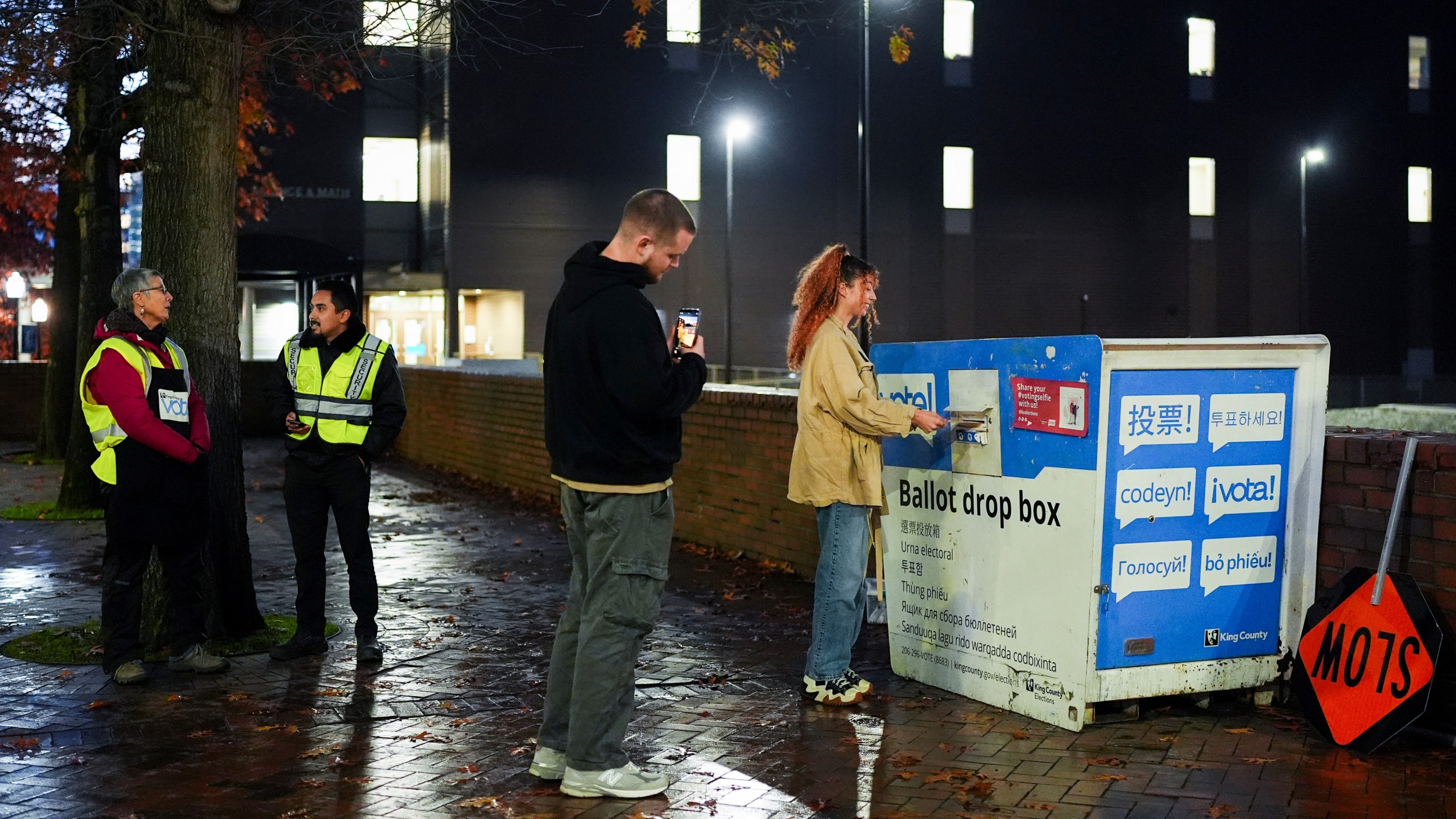 FILE - A voter poses for a photo as they place their ballot in a drop box on Election Day, Nov. 5, 2024, in Seattle. (AP Photo/Lindsey Wasson, File)