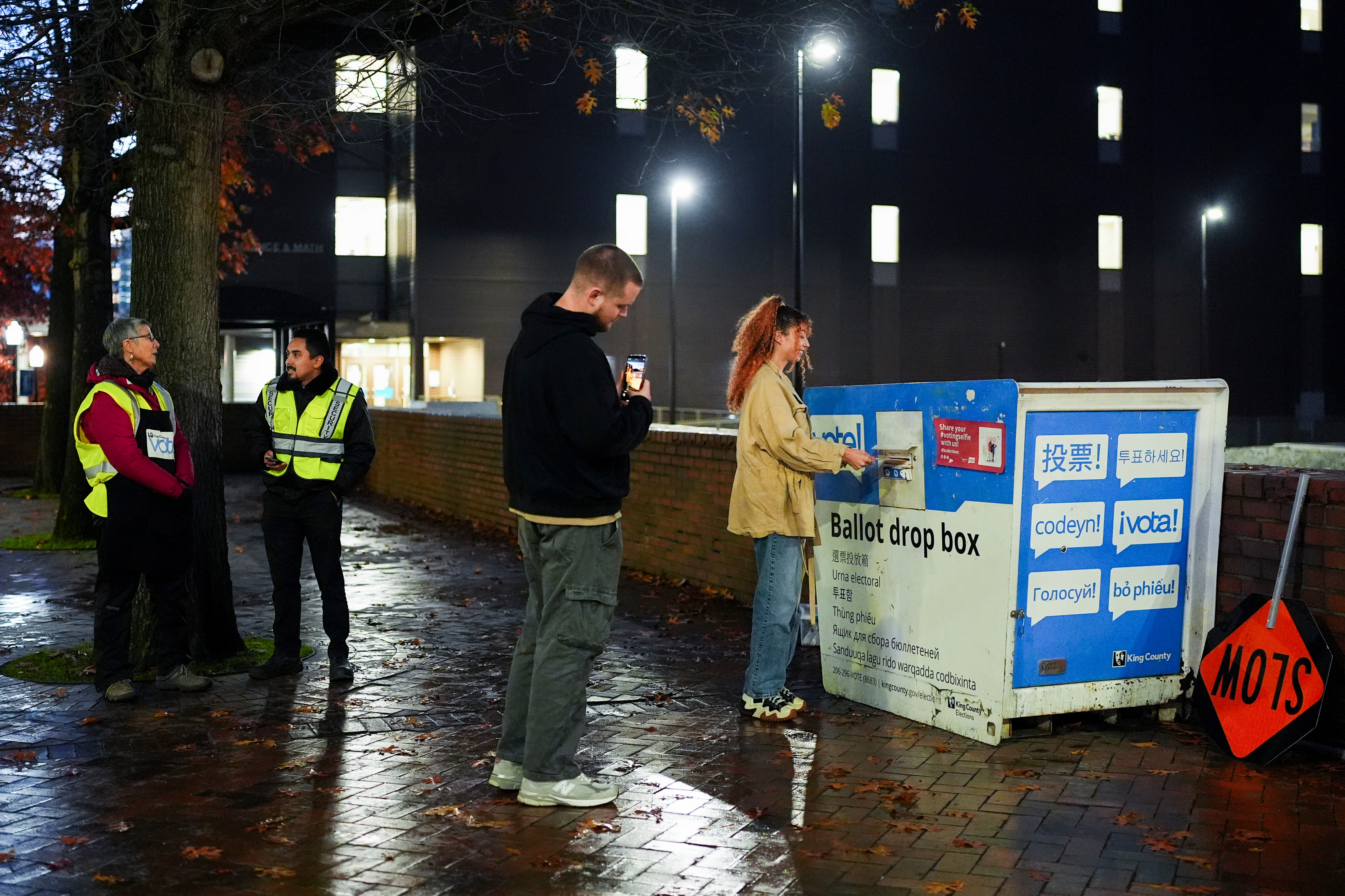 FILE - A voter poses for a photo as they place their ballot in a drop box on Election Day, Nov. 5, 2024, in Seattle. (AP Photo/Lindsey Wasson, File)
