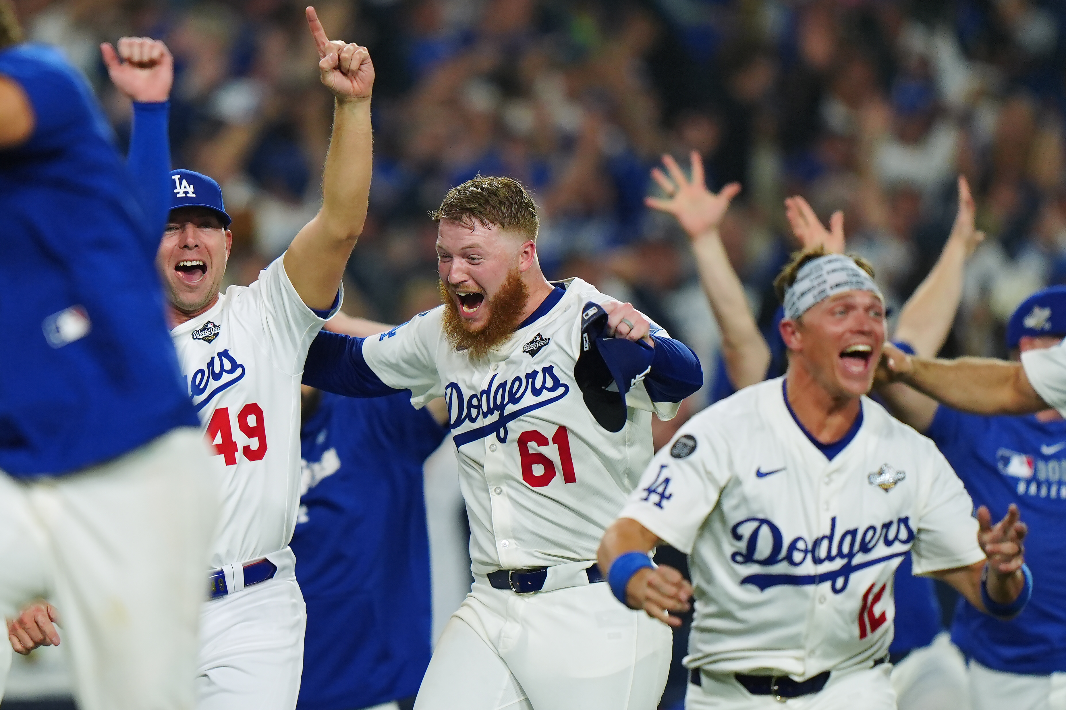 Winning Los Angeles Dodgers pitcher Will Klein (61) celebrates with Blake Treinen (49) and Alex Call (12) during 18th inning Game 3 World Series playoff MLB baseball action in Los Angeles on Monday, Oct. 27, 2025. (Frank Gunn/The Canadian Press via AP)