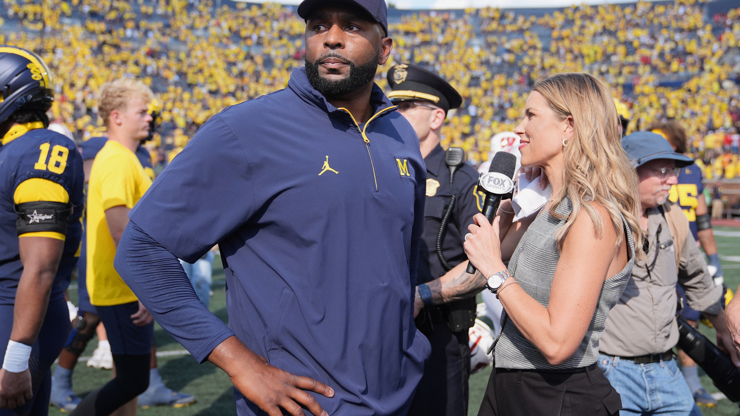 Michigan head coach Sherrone Moore gives a news interview after the team's win in an NCAA college football game against Wisconsin, Saturday, Oct. 4, 2025, in Ann Arbor, Mich. (AP Photo/Ryan Sun)