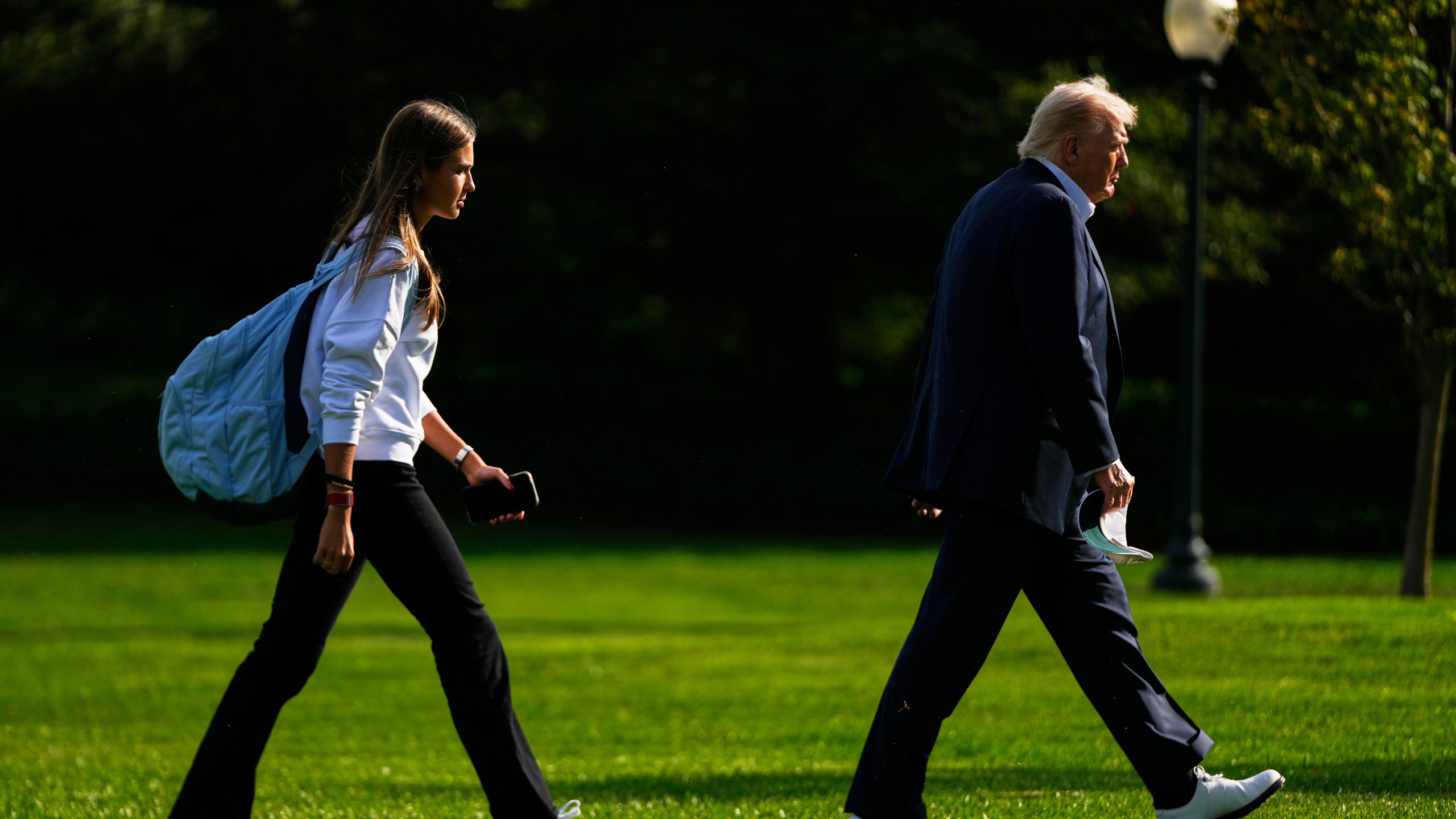FILE - President Donald Trump, right, arrives with his granddaughter Kai Trump at the White House, Friday, Sept. 26, 2025, in Washington. (AP Photo/Julia Demaree Nikhinson, file)