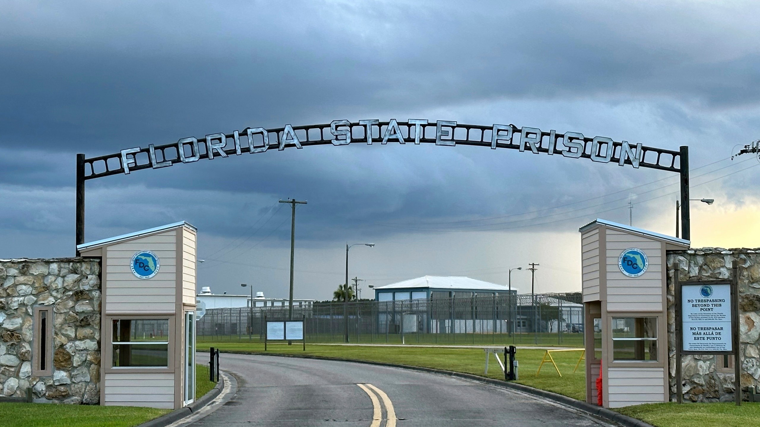 FILE - Clouds hover over the entrance of the Florida State Prison in Starke, Fla., Aug. 3, 2023. (AP Photo/Curt Anderson, file)