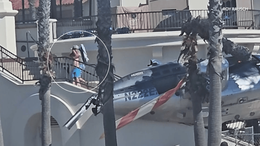 A child being pulled from the wreckage after a helicopter crashed near a hotel in Huntington Beach on Oct. 11, 2025. (Rory Rausch)